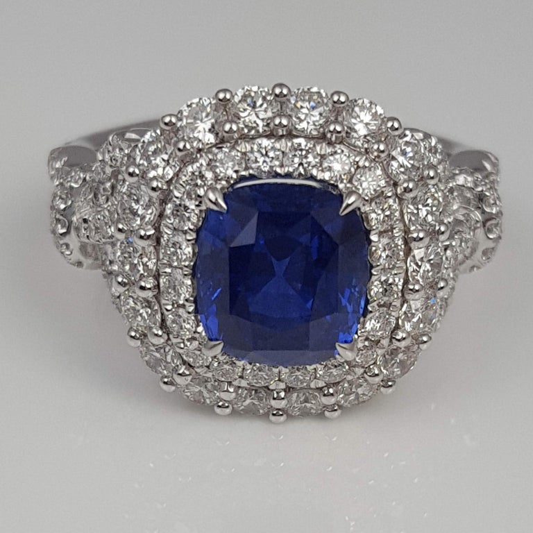 With a GIA Certified 2.55 carat cushion cut Ceylon Sapphire center, set inside a double halo of round white diamonds (total diamond weight 1.61 carats), this ring shines from every angle.

GIA Certification details (see photo):
The center sapphire