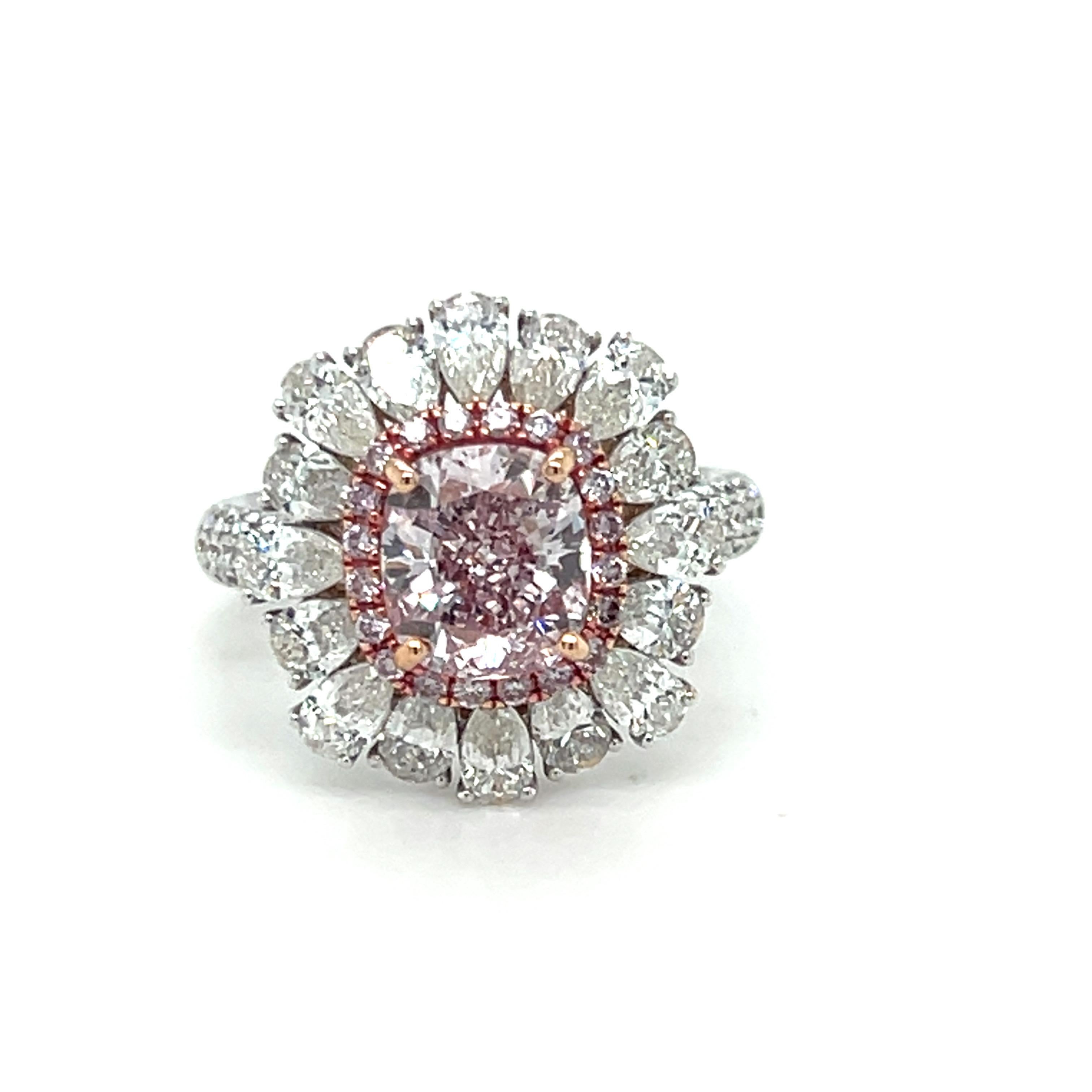 This GIA-certified 2.55-carat cushion-cut pinkish-purple, SI2 diamond is beautifully framed by a halo of 0.20 carats of pink diamonds, with an outer layer of pear-shape diamonds totaling 2.44 carats. Expertly crafted in 18K two-tone gold, this ring