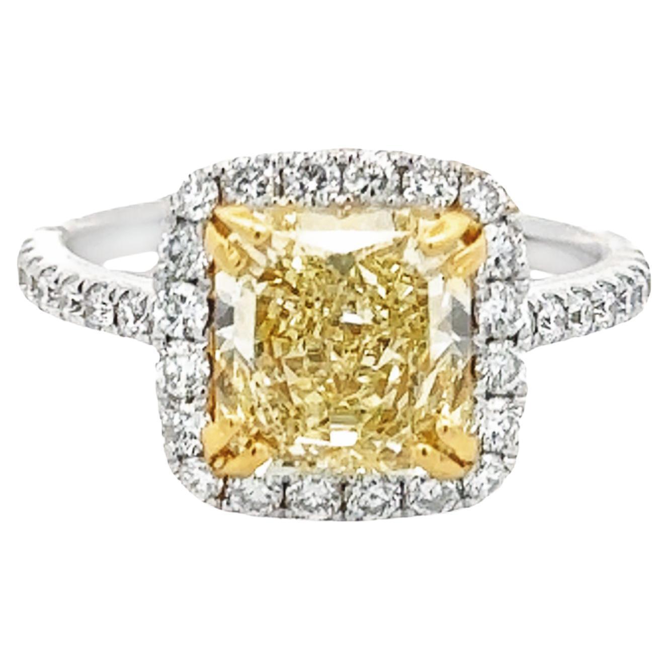 GIA Certified 2.55 carat Fancy Light Yellow VS1 Radiant Cut Halo Ring For Sale