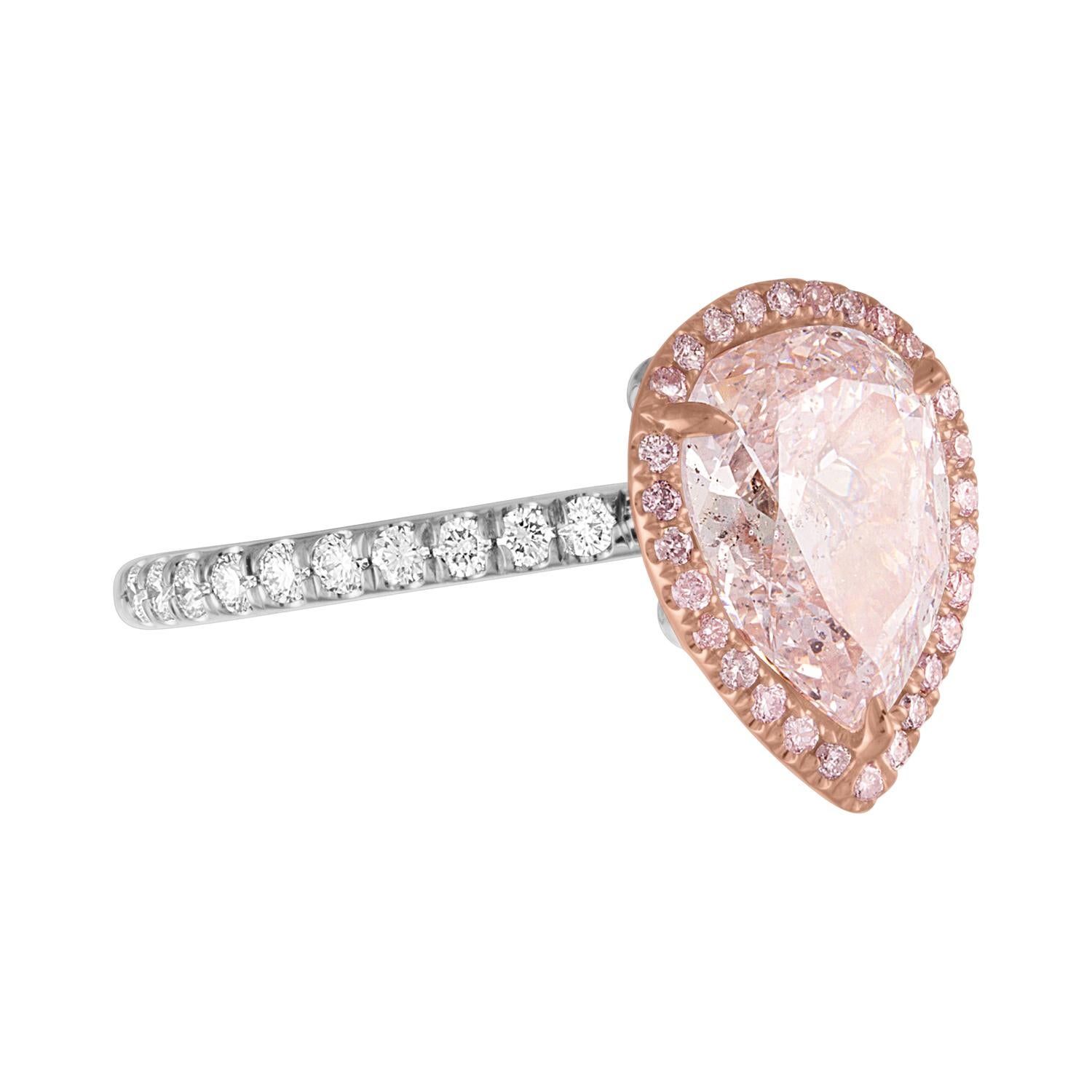 2.56 Carat Pear Shape is set in Two tone hand Crafted Mounting, Rose Gold & Platinum.
The Pear Shape is set in the center surrounding Pink Diamonds Pave' setting. The Shank is also dressed in White with White Diamonds on it.
The Pear Shape is GIA