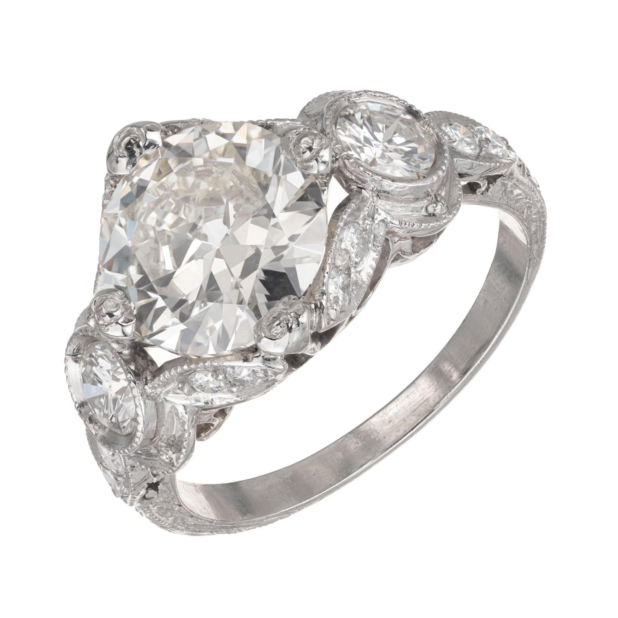 Platinum Art Deco 1930s  2.59 ct Transitional Cut Diamond engagement ring. Original solid Platinum open work and hand engraving setting with a round brilliant diamond center stone, accented with two round brilliant cut side diamonds. . 

1 GIA