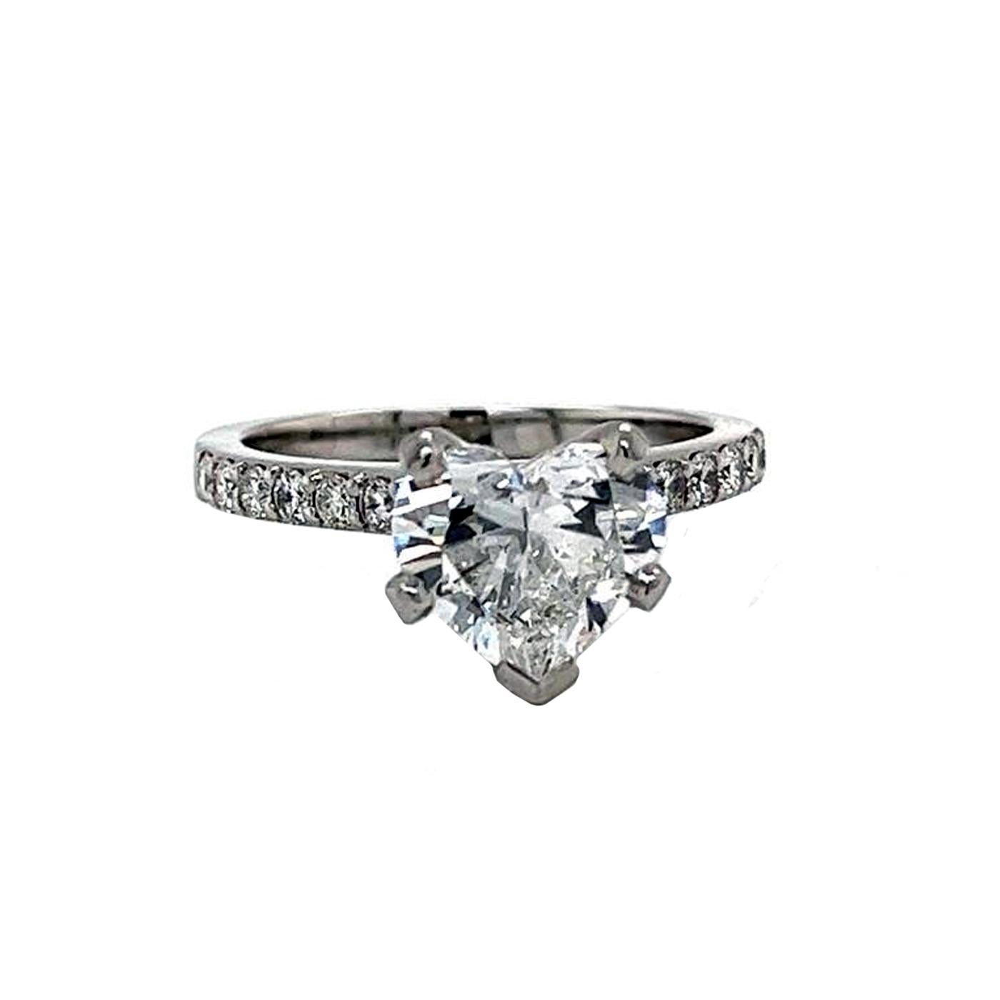 One lady's platinum (stamped) and diamond ring. The brightly polished ring is mounted is cast/assemble manufactured of diamond-embellished cathedral shoulders design.

The ring contains one heart-cut diamond. The weight is 2.60 carats, The clarity
