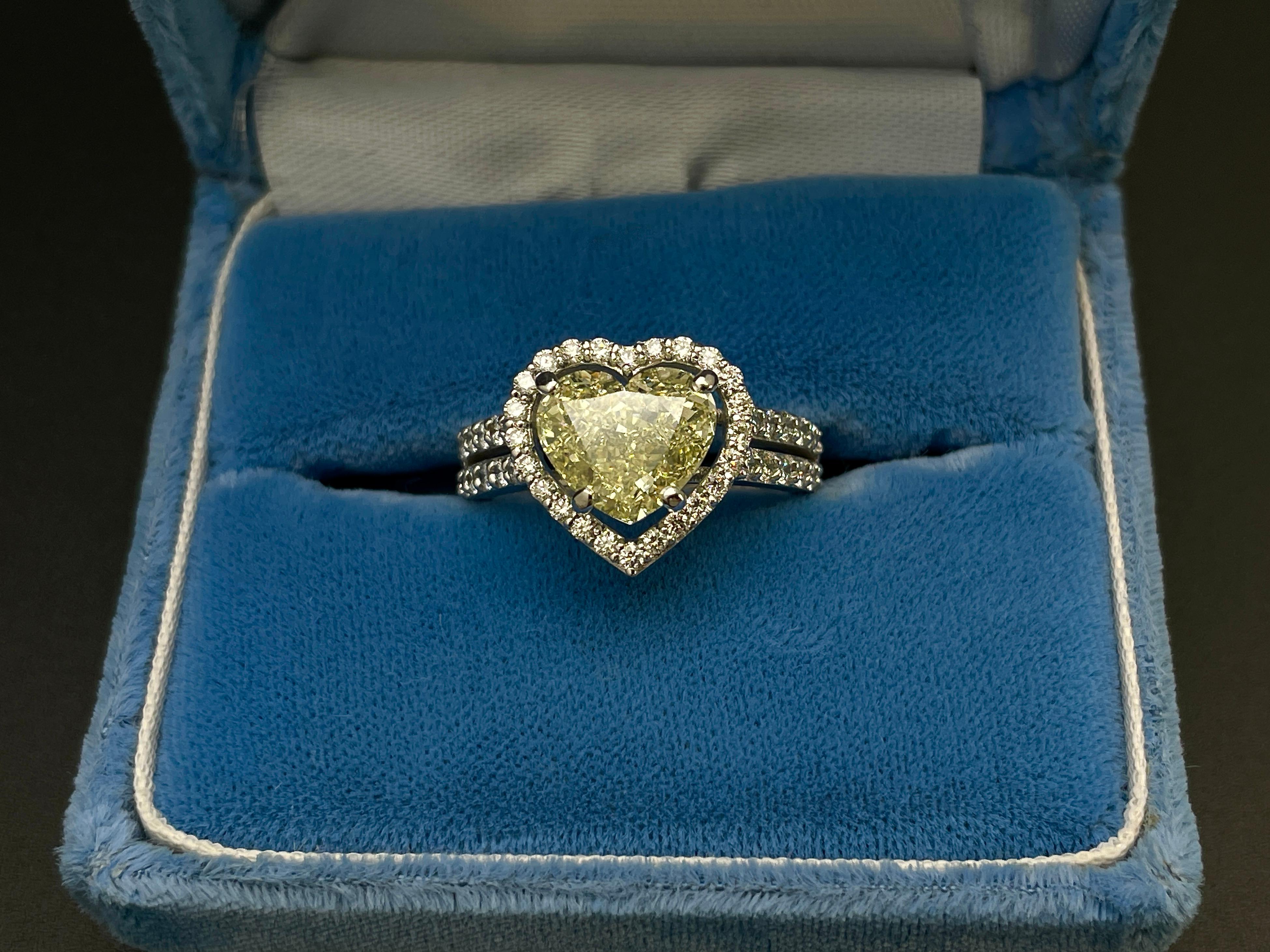 This beautiful 18K white gold engagement ring features a GIA certified 2.61 carat heart brilliant cut natural fancy yellow diamond, with near-flawless VVS2 clarity and a rich natural fancy yellow color. The diamond measures 8.23 x 9.48 x 4.52 mm,