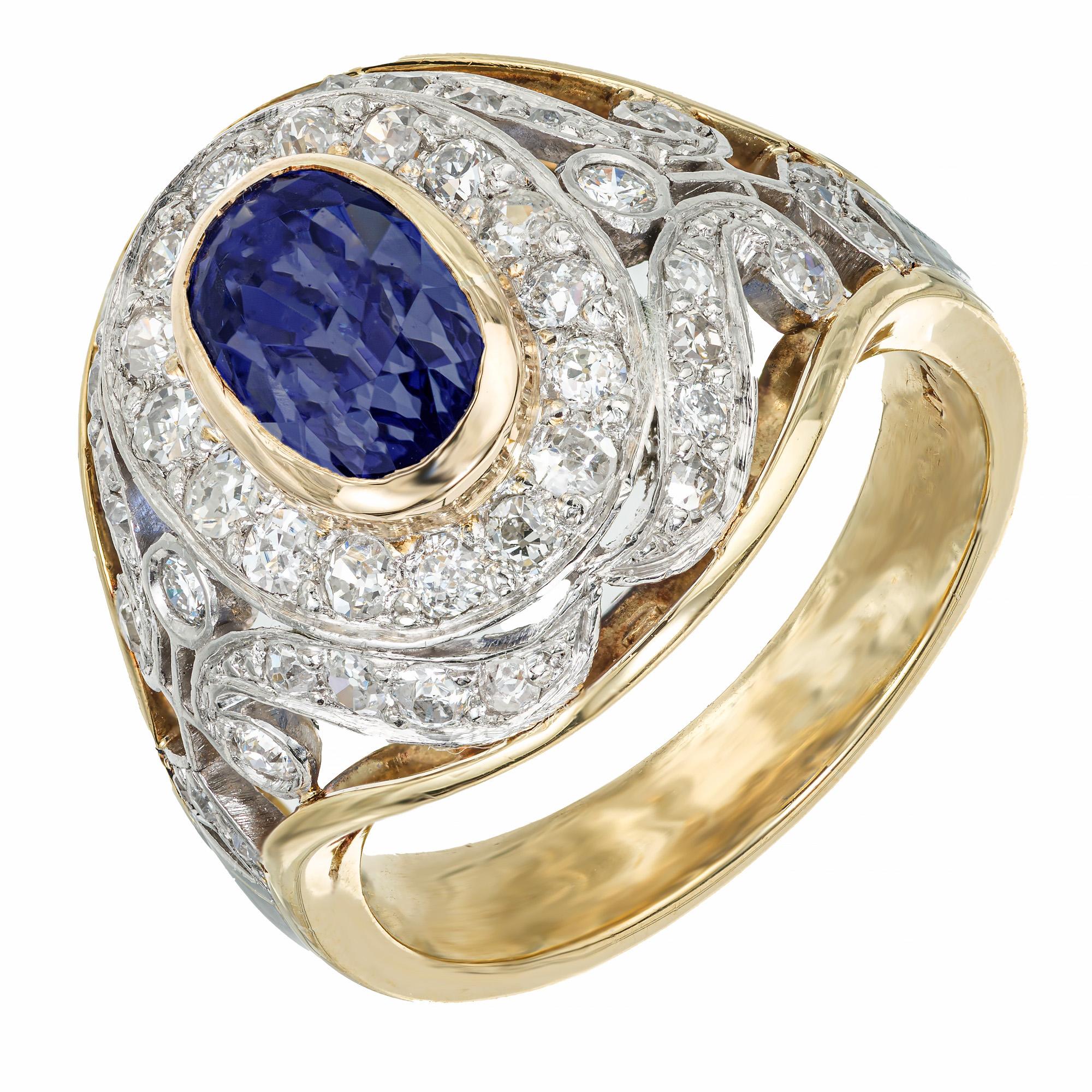 Natural certified oval Cornflower Sapphire and diamond cocktail ring. GIA certified oval bezel set blue sapphire center stone with 43 mixed Old European and rose cut diamonds set in platinum. The setting and shank is made of 18k yellow gold. The