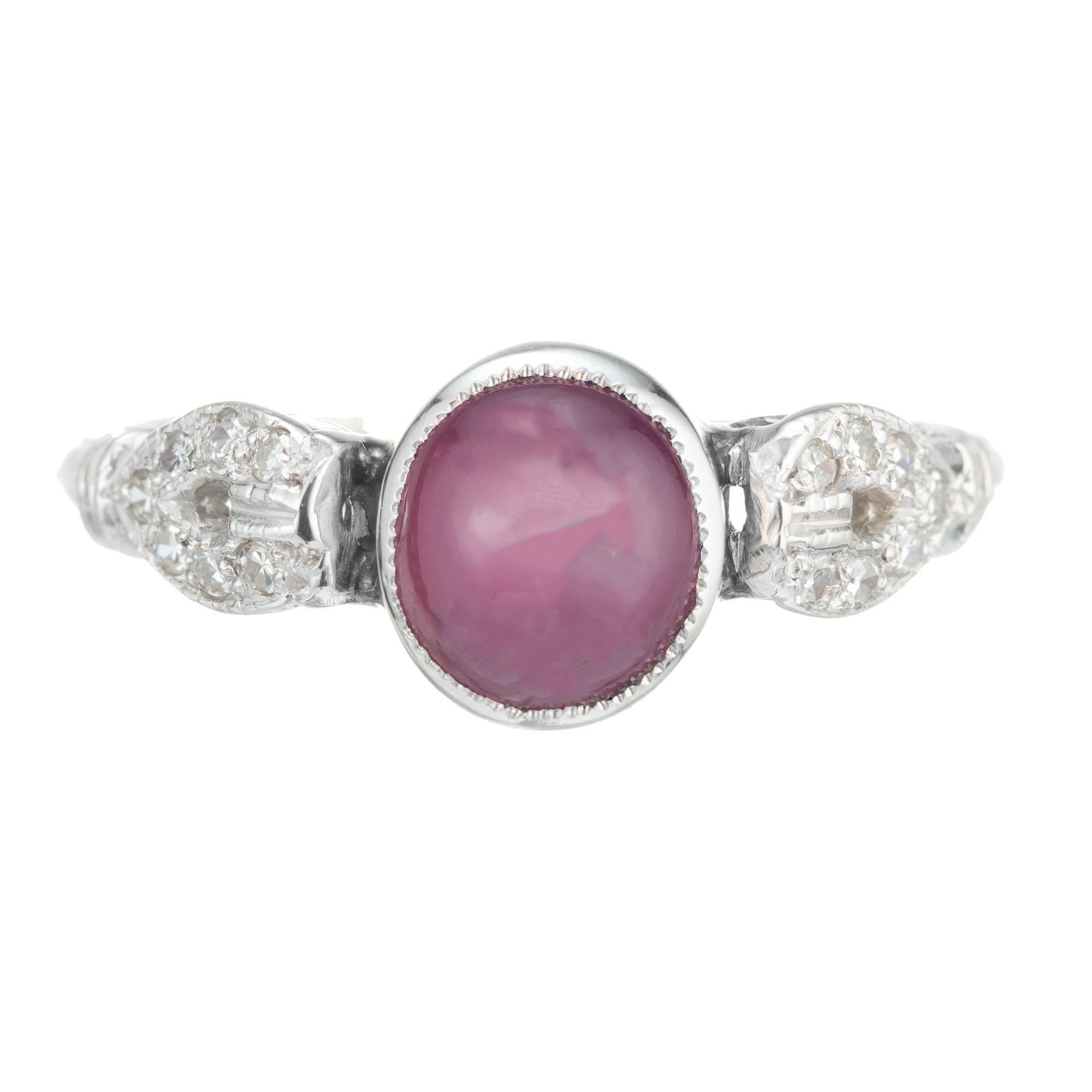 Star Ruby and diamond 1920's Art Deco engagement ring. GIA certified no heat cabochon star ruby bezel set center stone with 14 round accent diamonds in a platinum setting. The star is not easily seen under natural lighting. 

1 round star ruby