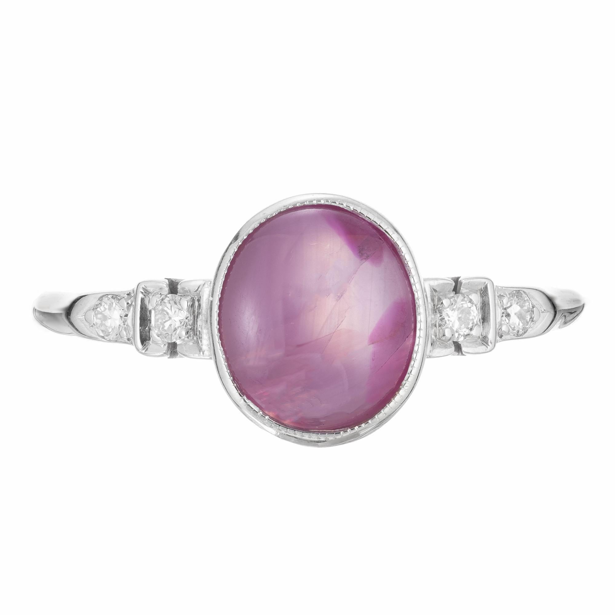 1940's Natural purple star Sapphire and diamond engagement ring. GIA certified oval cabochon bezel set star sapphire with 4 round accent diamonds in a 14k white gold setting. GIA certified natural, no enhancements.

1 purple splotches natural oval