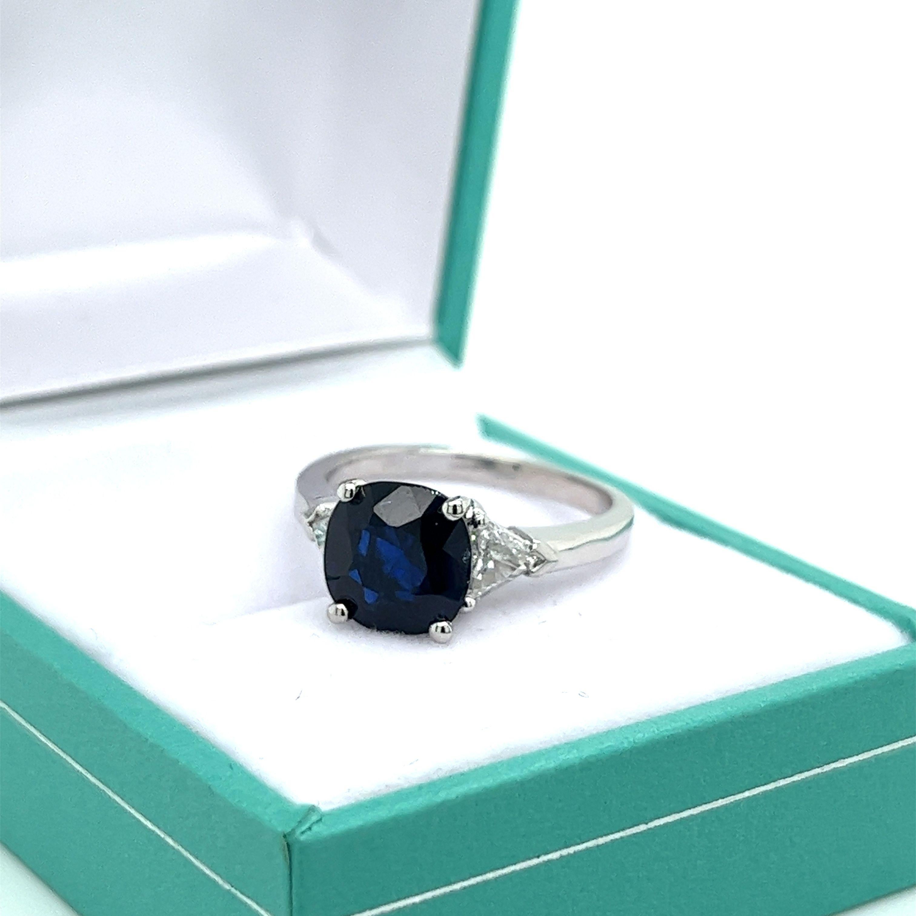 Cushion Cut GIA Certified 2.63 Carat Blue Sapphire Ring with Trillion Cut Diamond Sidestones For Sale