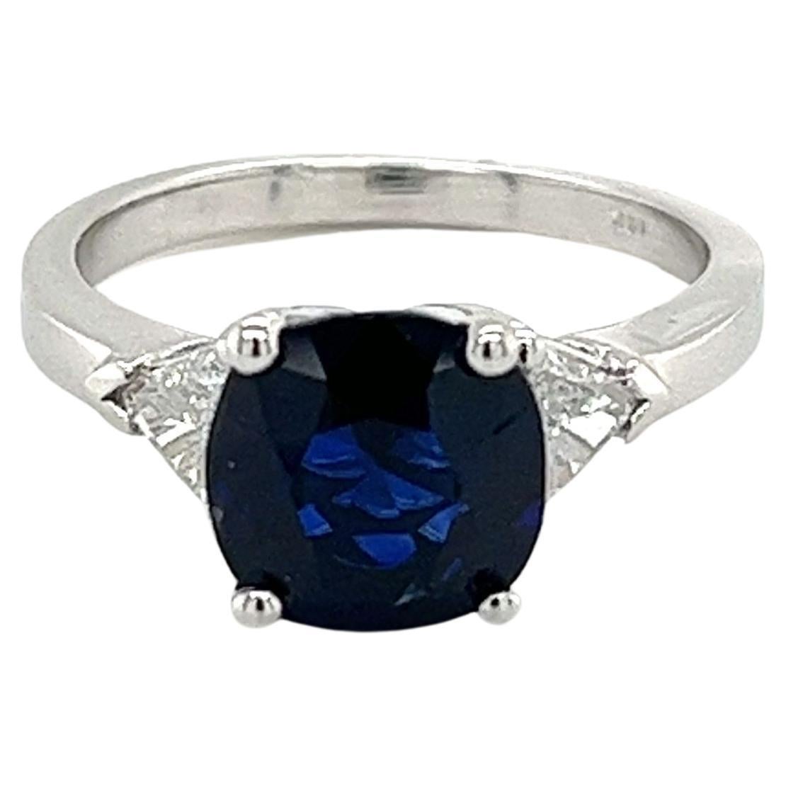 GIA Certified 2.63 Carat Blue Sapphire Ring with Trillion Cut Diamond Sidestones For Sale