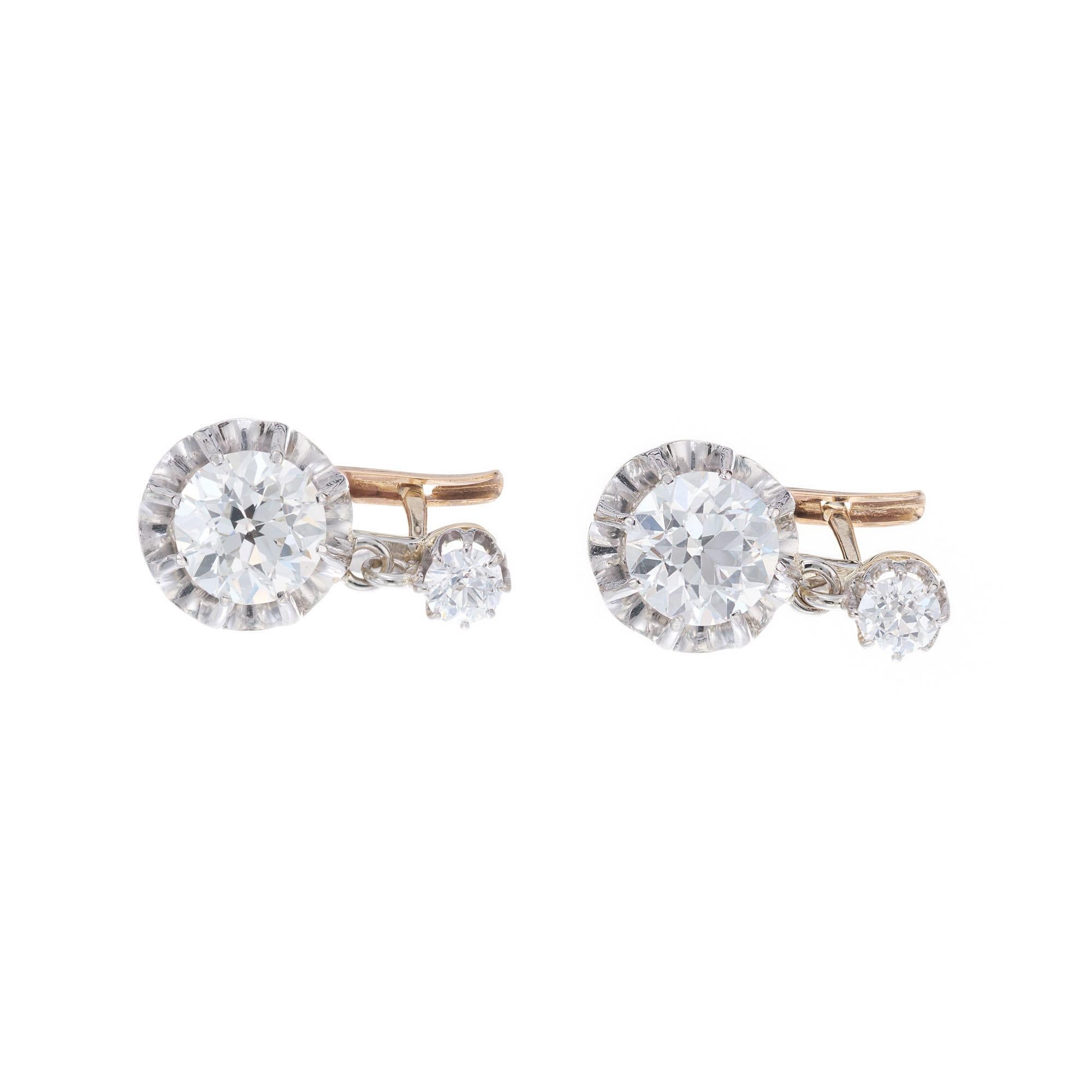 Early 1900's Old European brilliant cut diamond dangle earrings. 2 GIA certified diamonds set in Platinum, accented with 2 old European top diamonds. 18k yellow gold lever backs. 

1 old European brilliant cut diamond, approx. total weight 1.32cts,