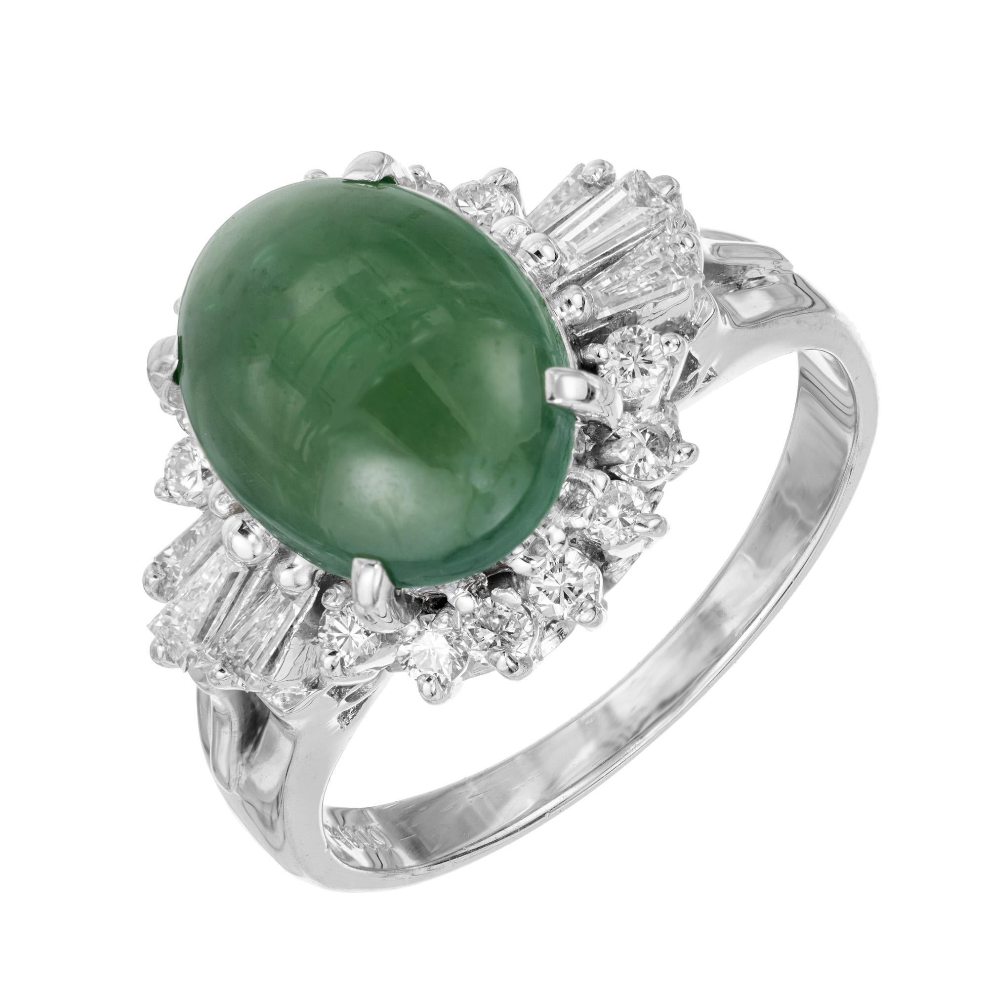 Ompchacite Jade and diamond halo ring. Oval cabochon green omphacite jade center stone with a halo of 14 round cut diamonds accented with 3 tapered baguettes on each side in a platinum setting. GIA Certified green translucent omphacite jade as