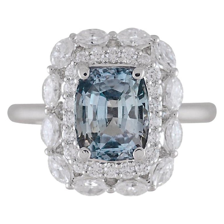 With a GIA Certified 2.69 carat cushion cut Gray-Blue sapphire center, set inside a double halo of round and marquise cut white diamonds (total diamond weight 0.76 carats), this ring shines from every angle.

GIA Certification details (see