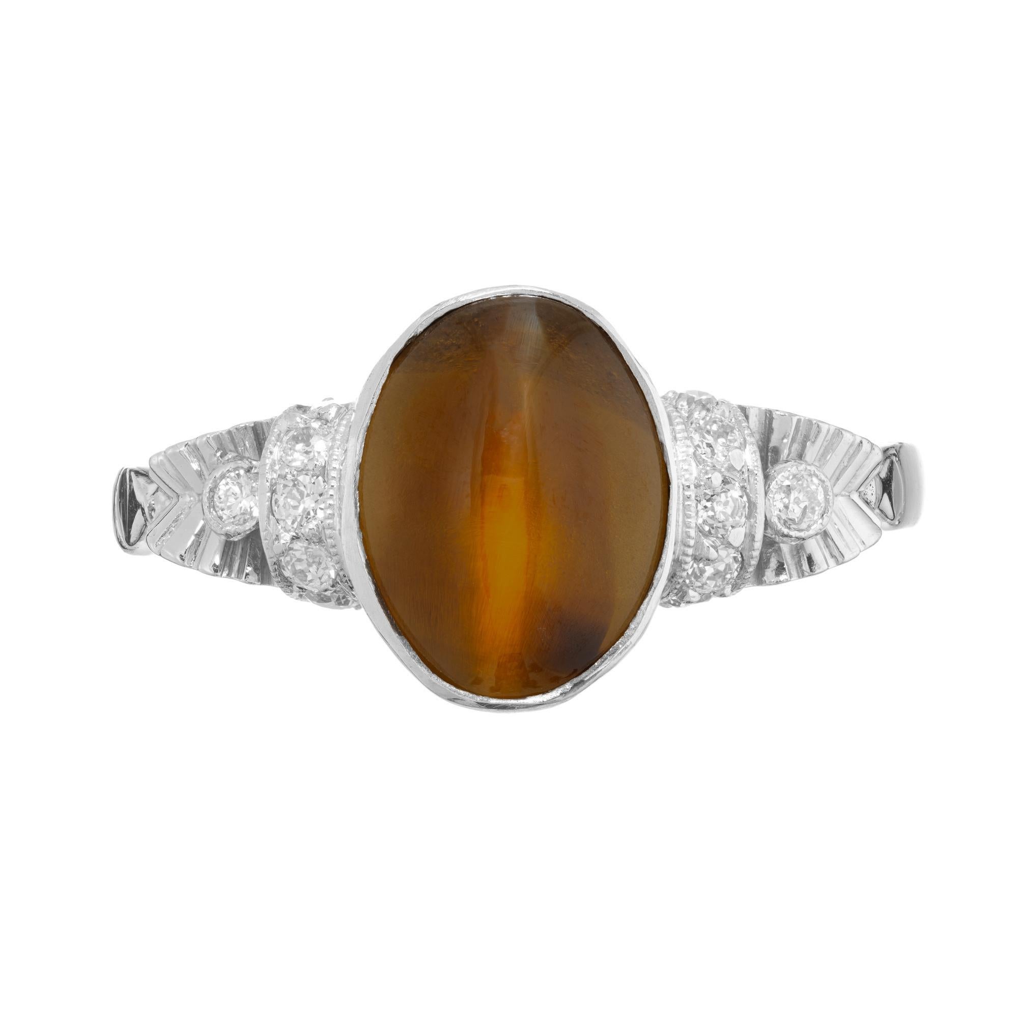 1920's Art Deco 2.71ct Chrysoberyl Cat’s Eye and diamond Platinum engagement ring. The center stone is a cabochon, 2.71cts oval Chrysoberyl. bezel set in a platinum mounting adorned with 12 round brilliant cut diamonds. GIA certified natural bright