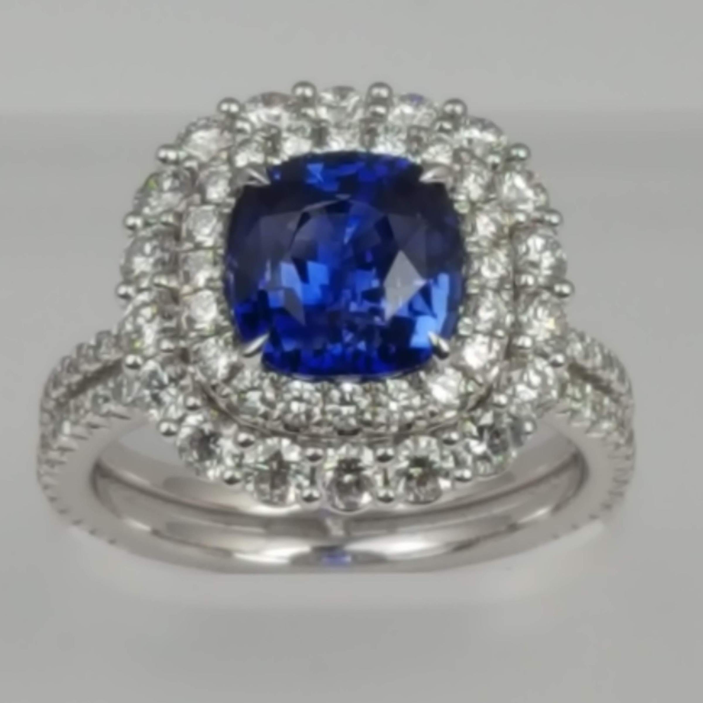 With a GIA Certified 2.72 carat cushion cut Ceylon Sapphire center, set inside a double halo of round white diamonds (total diamond weight 1.56 carats), this ring shines from every angle.

GIA Certification details (see photo):
The center sapphire