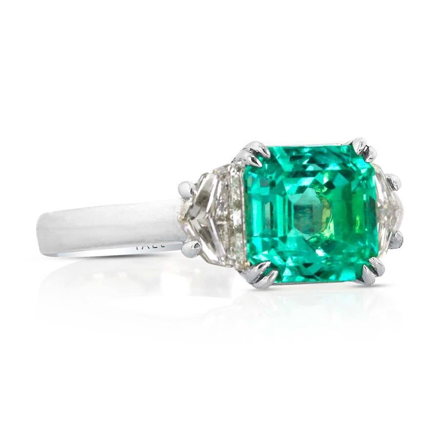 Clean, classic design emphasis the simplistic beauty of a grass-green emerald flanked by sparkling diamonds.

Emerald-Cut Emerald: 2.72cts.
Cadillac-Cut Diamonds: 0.61ct. Total Weight
Platinum and 18kt Gold