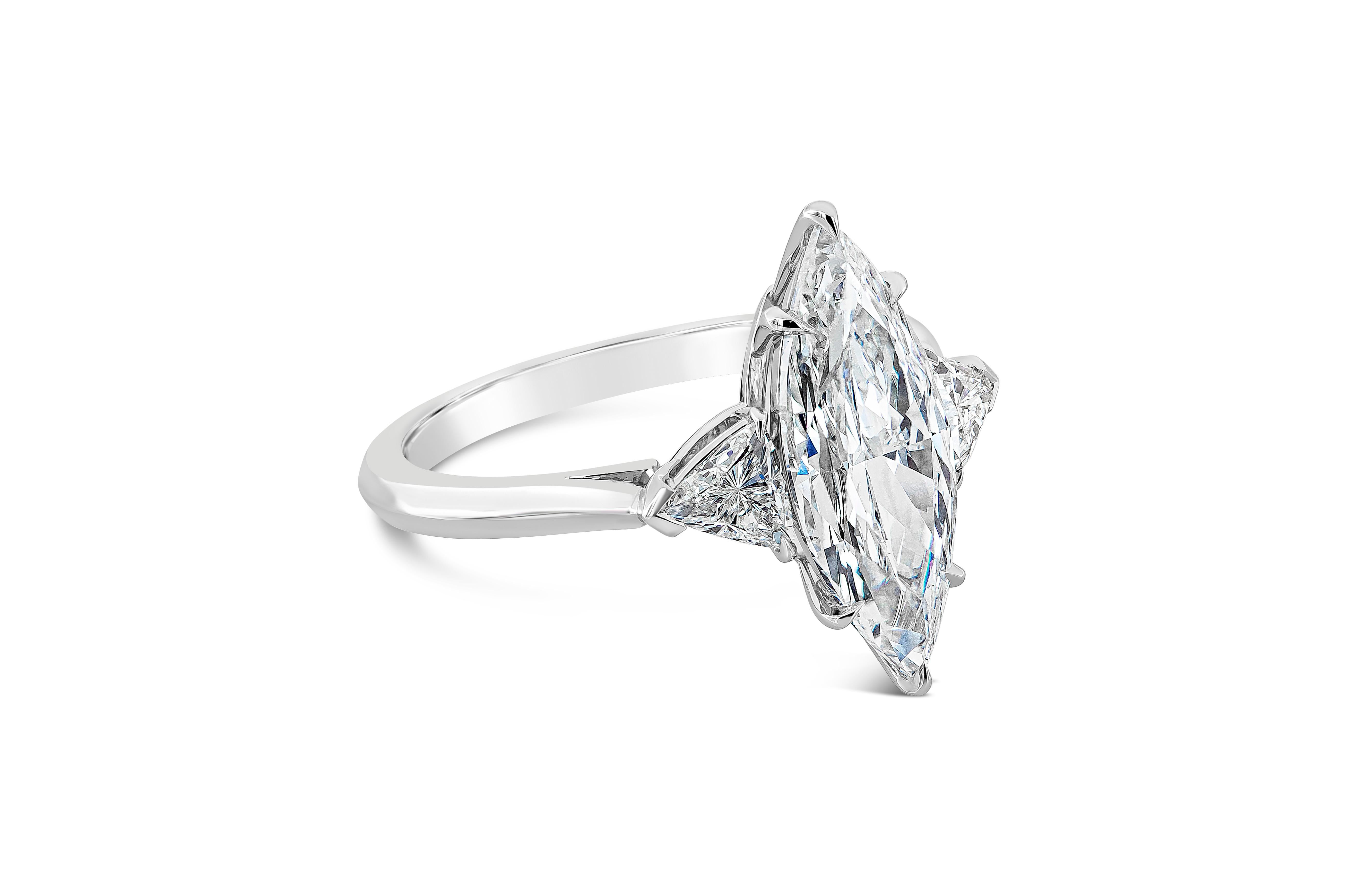 Featuring 2.72 carats marquise cut diamond certified by GIA as D color, SI1 in clarity. Flanking the center stone are two trillion cut diamonds weighing 0.56 carats total, D color and VS in clarity. Set in a polished knife-edge setting made in