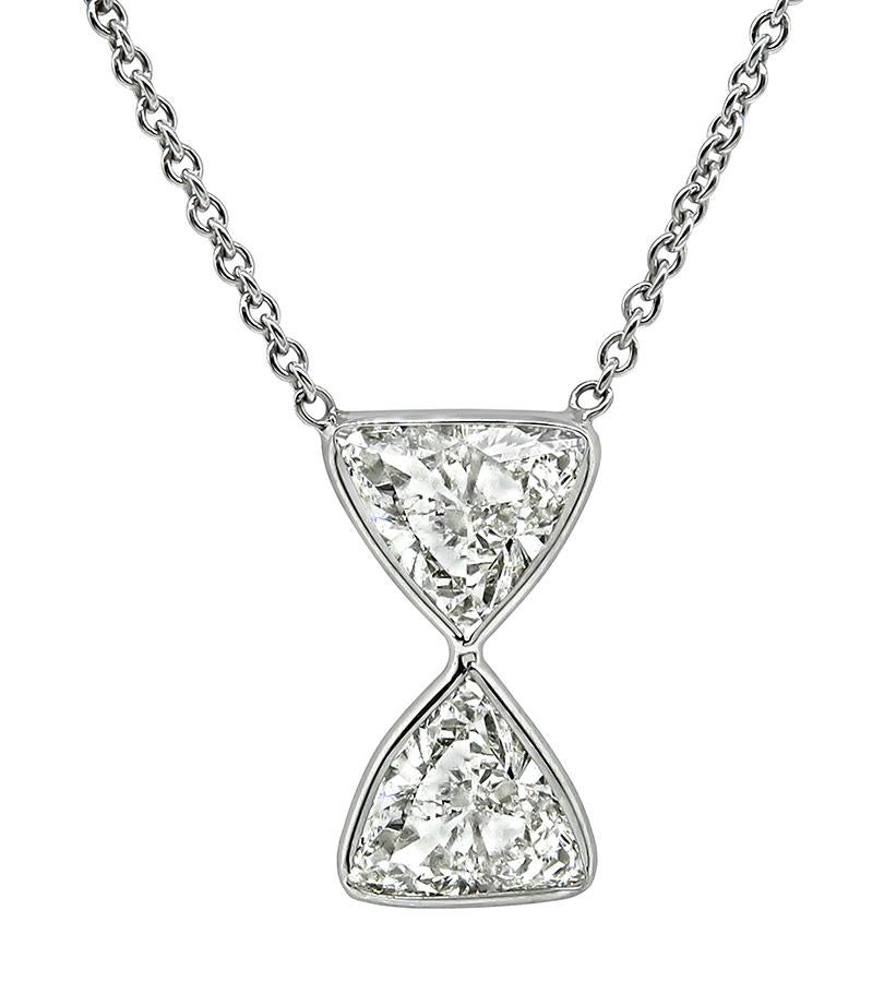 This is a charming 14k white gold hour glass pendant necklace. The pendant is set with sparkling GIA certified trilliant cut diamonds that weigh 1.48ct and 1.26ct. The color of the diamonds is J with SI2 clarity and I with SI1 clarity respectively.