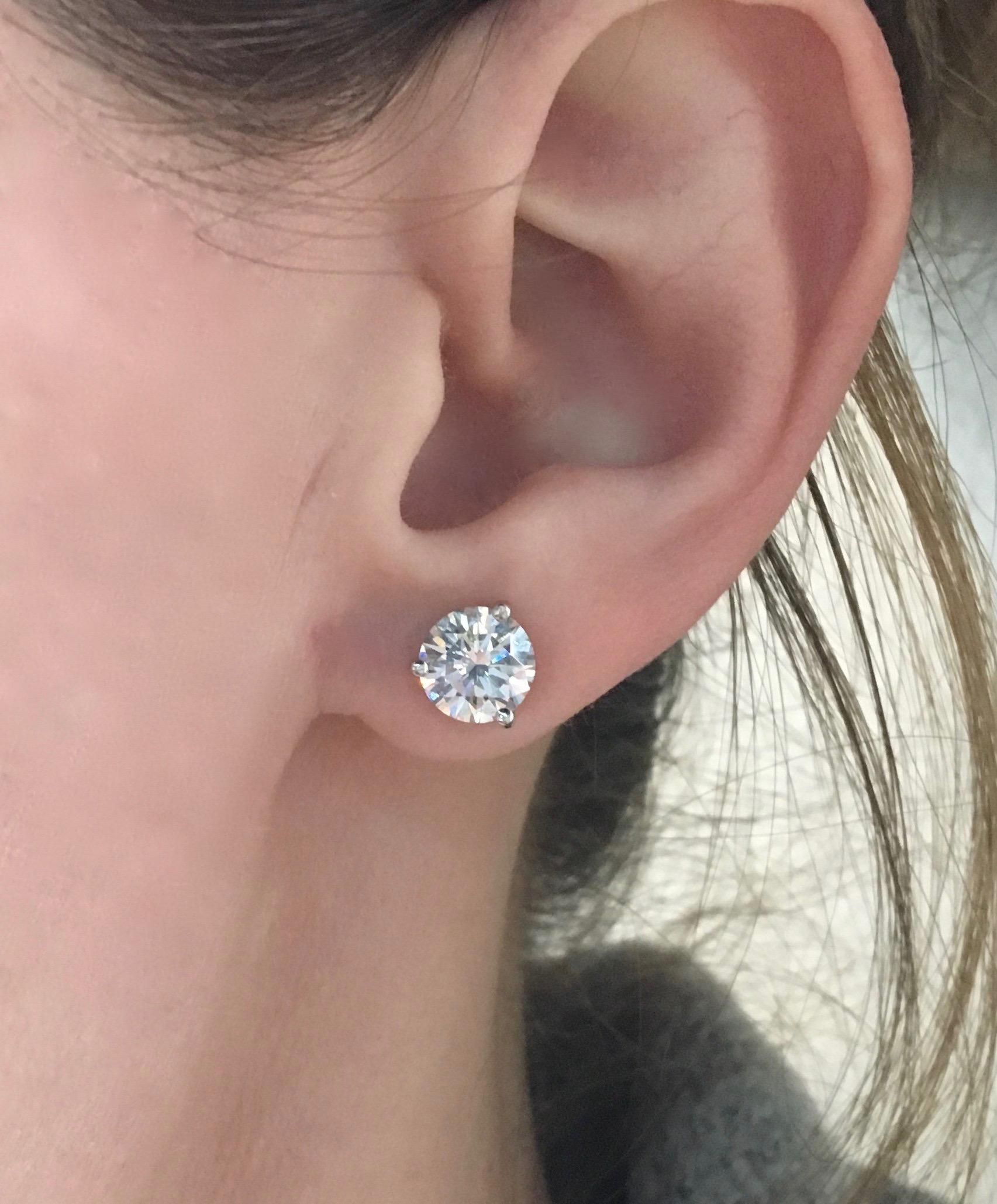 GIA Certified 2.75ctw classic round brilliant cut diamond earrings set 18K white gold martini style baskets.

GIA Certified both diamonds are laser scribed with their corresponding certification numbers.
GIA #12364436 1.37CT
GIA#12753901