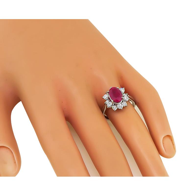 This is an elegant platinum engagement ring. The ring is centered with a lovely GIA certified oval cut Burma ruby that weighs 2.75ct. The ruby is accentuated by sparkling round cut diamonds that weigh approximately 1.00ct. The color of these