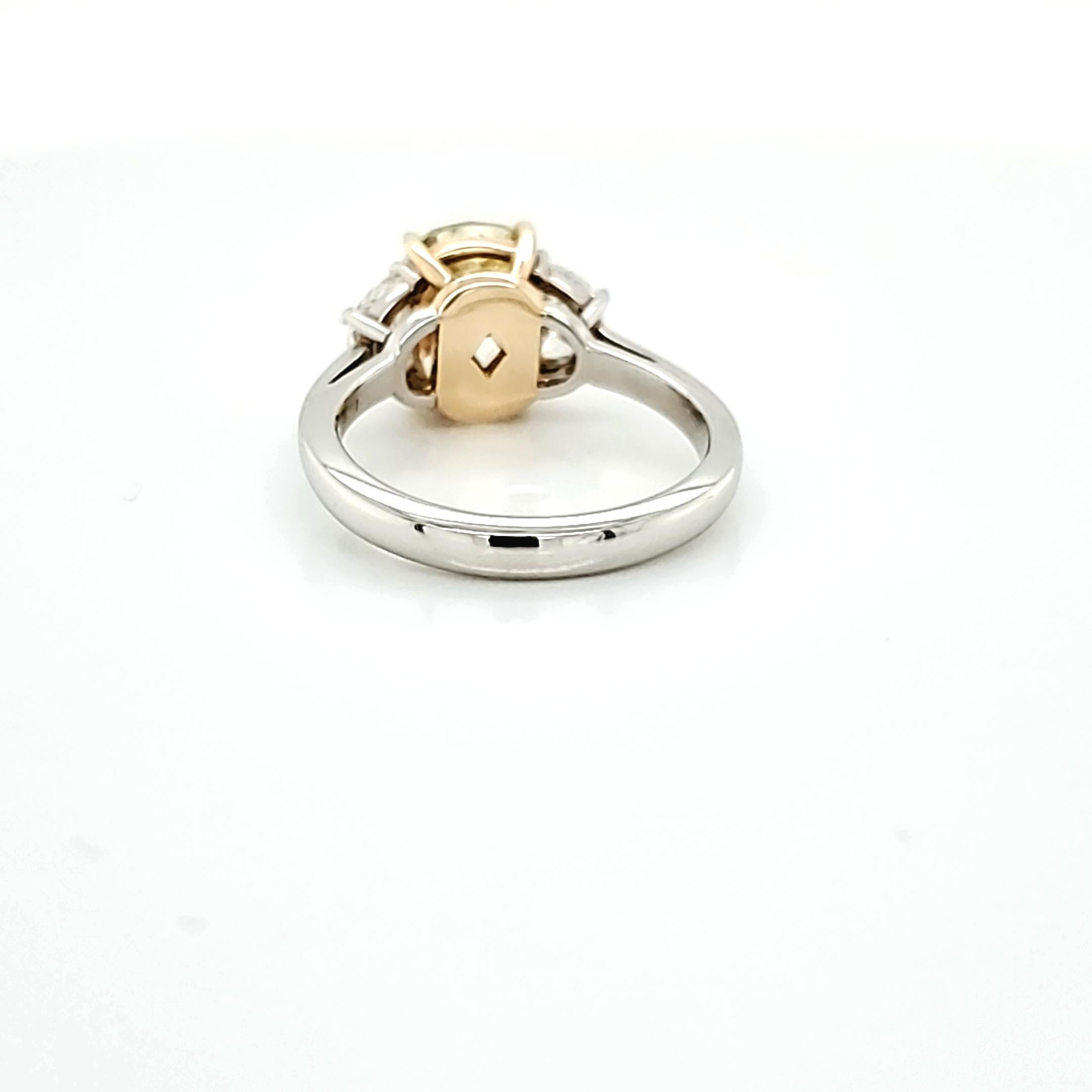 GIA Certified 2.80 Carat Fancy Yellow Cushion Cut Diamond Three-Stone Ring For Sale 2