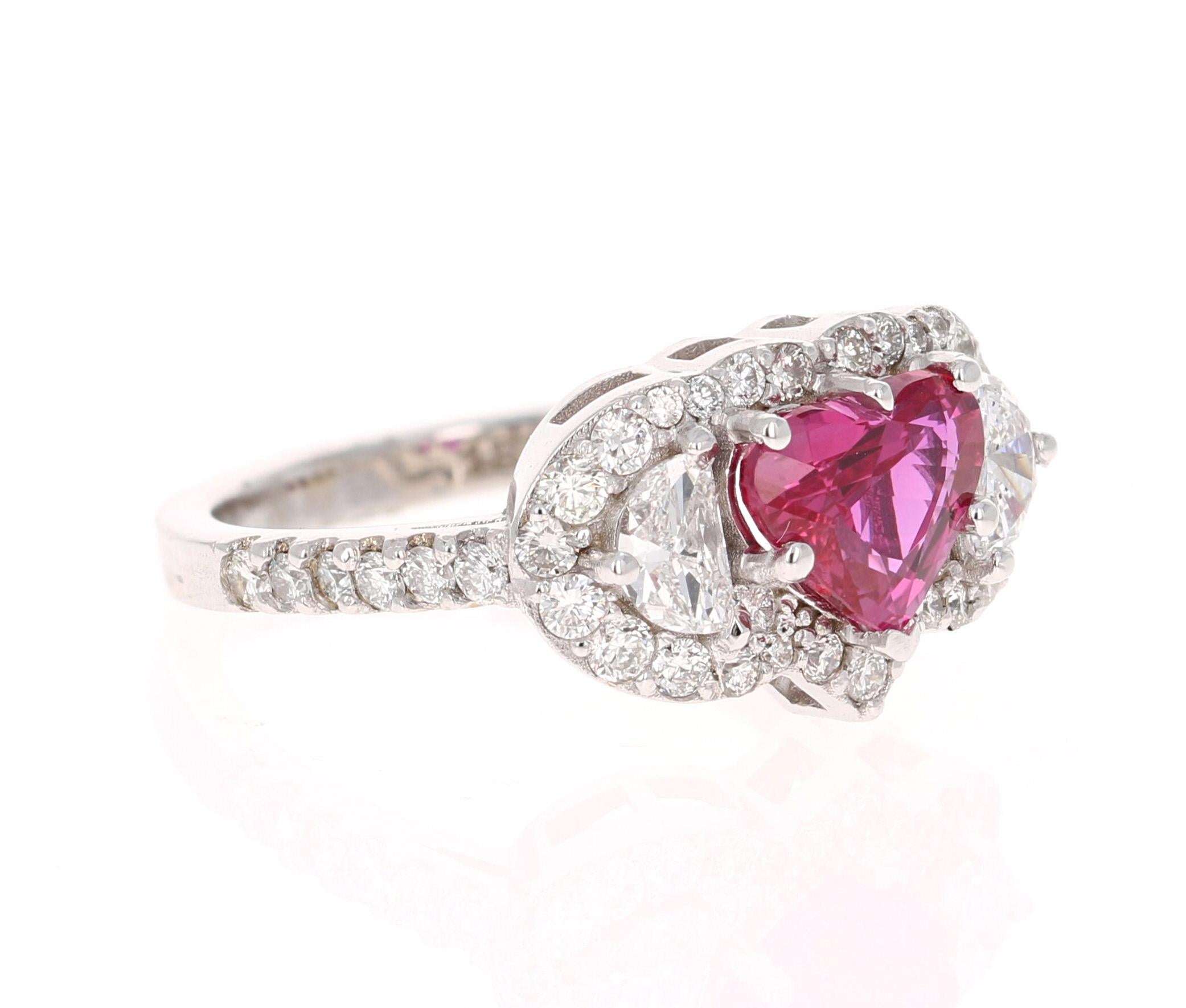 This ring has a stunning Heart Cut GIA Certified Ruby that weighs 1.73 carats. The Ruby is Natural and has no indications of Heating. The measurements of the heart are approximately 6.6 mm x 8 mm. 
The ring is surrounded by 2 Half Moon Cut Diamonds