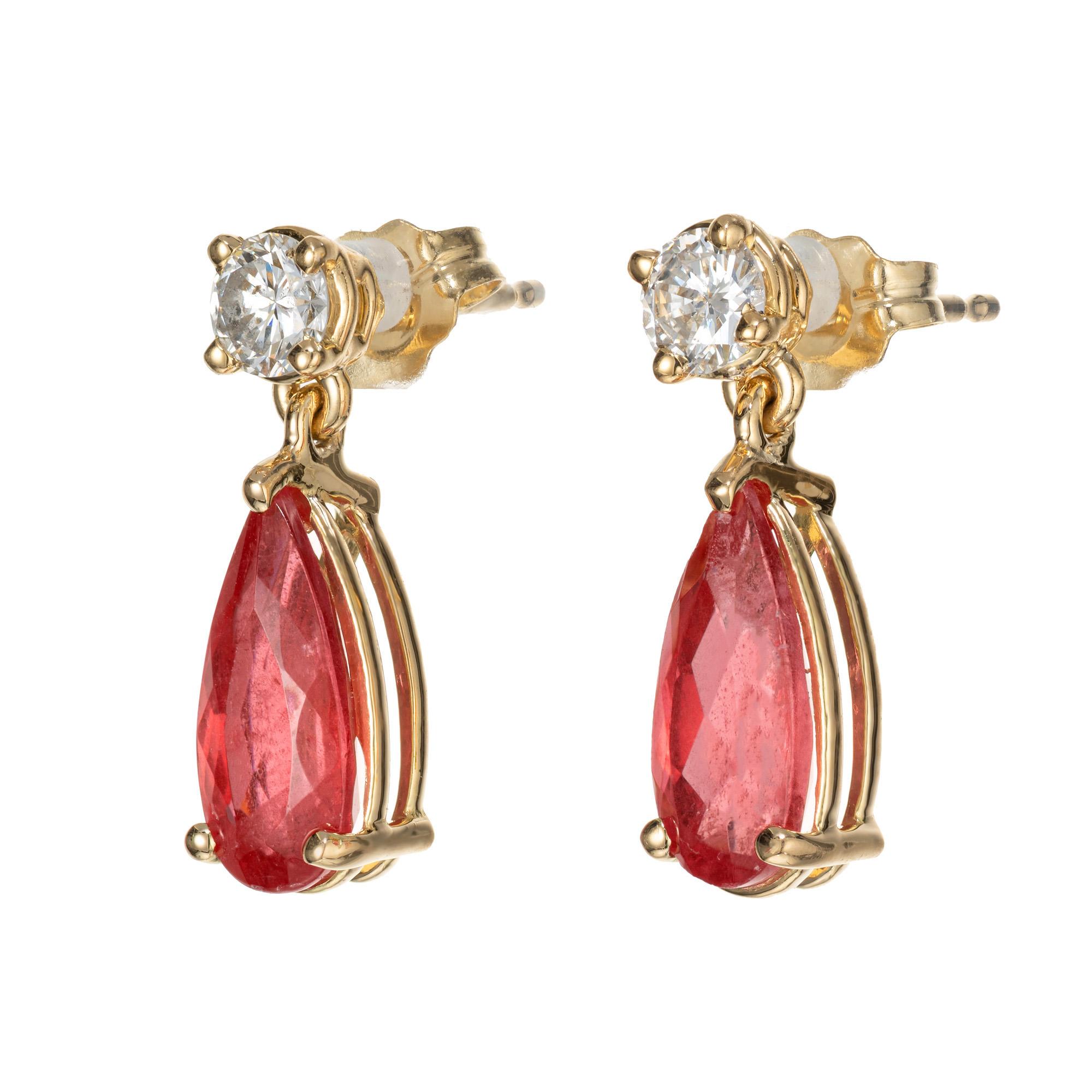 Rare orange red rodonite diamond dangle earrings. Desined and crafted in the Peter Suchy workshop

2 pear shape orangy red rhodonite, approx. 2.81cts GIA Certificate # 2223381437
2 round diamons, H-I SI-I approx. .36cts 
18k yellow gold 
Stamped: