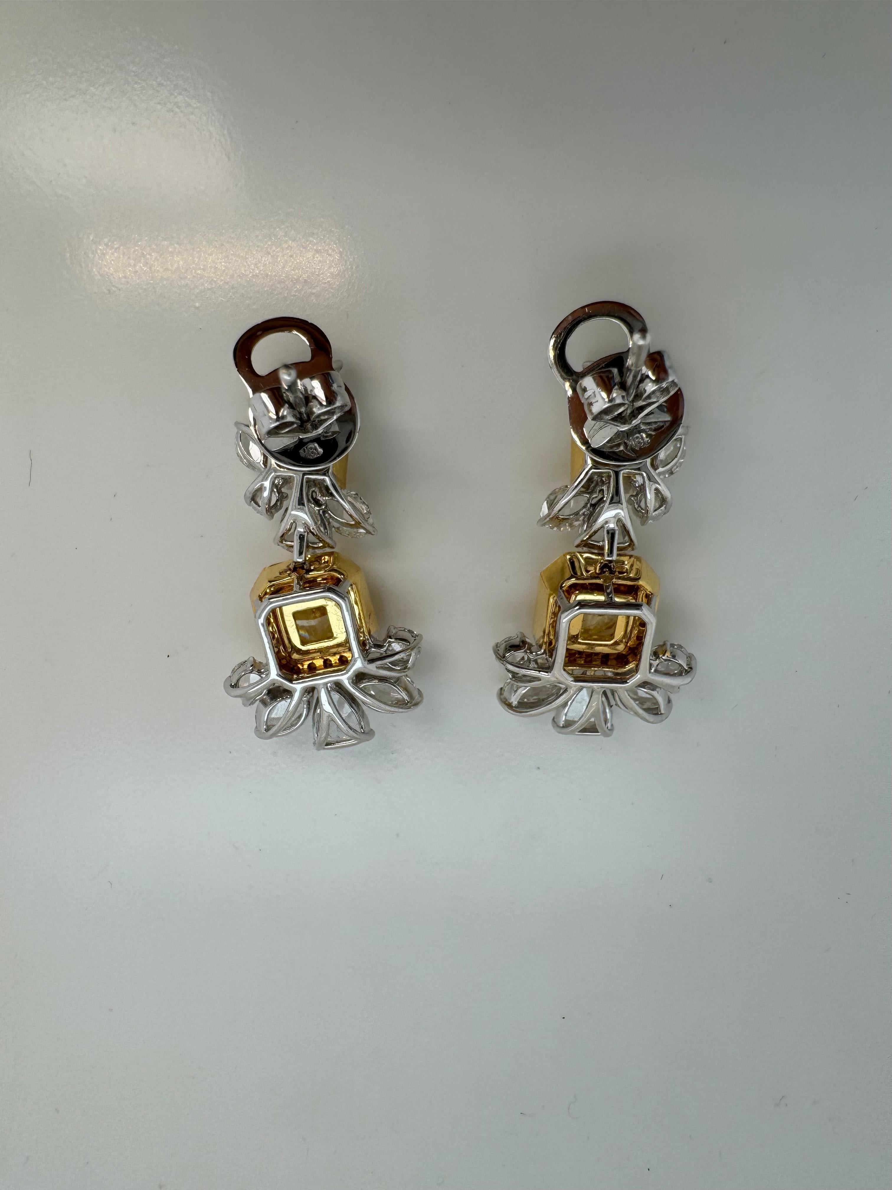 Add a touch of luxury to your look with these Rewa Jewelry earrings.

Each earring features a GIA Certified Cushion Cut Fancy Yellow diamond at its center, weighing 1.50 carats (GIA-5231004032) with a VS1 clarity grade, and 1.37 carats