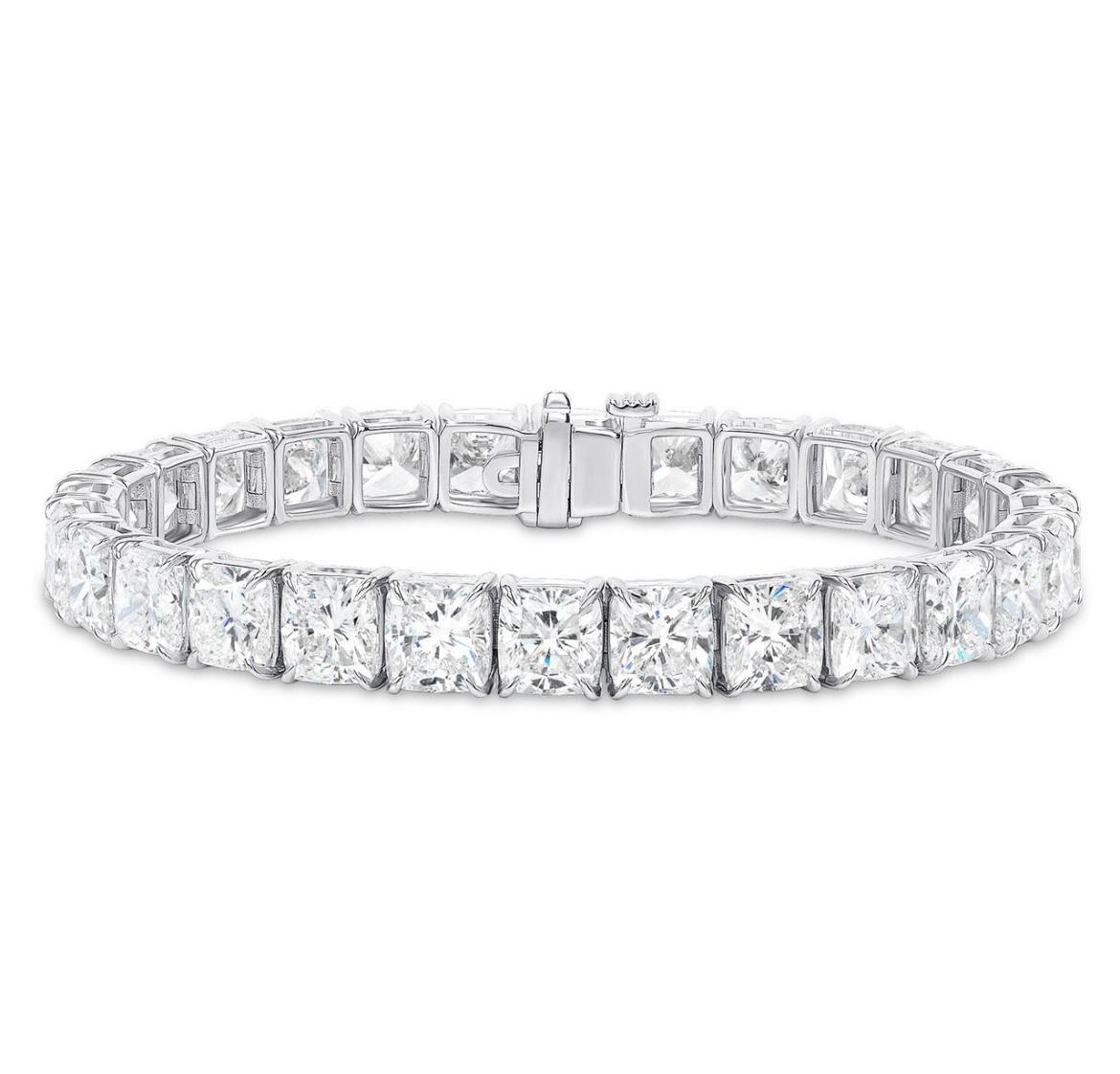 A magnificent tennis bracelet featuring 32 Cushion Cut Diamonds, each weighing 0.90 Carats for a total weight of 28.80 Carats. 
Each stone is certified by GIA as DEF in color and VVS-VS in clarity. 

Handmade in Platinum. 
Measuring 7 inches. 