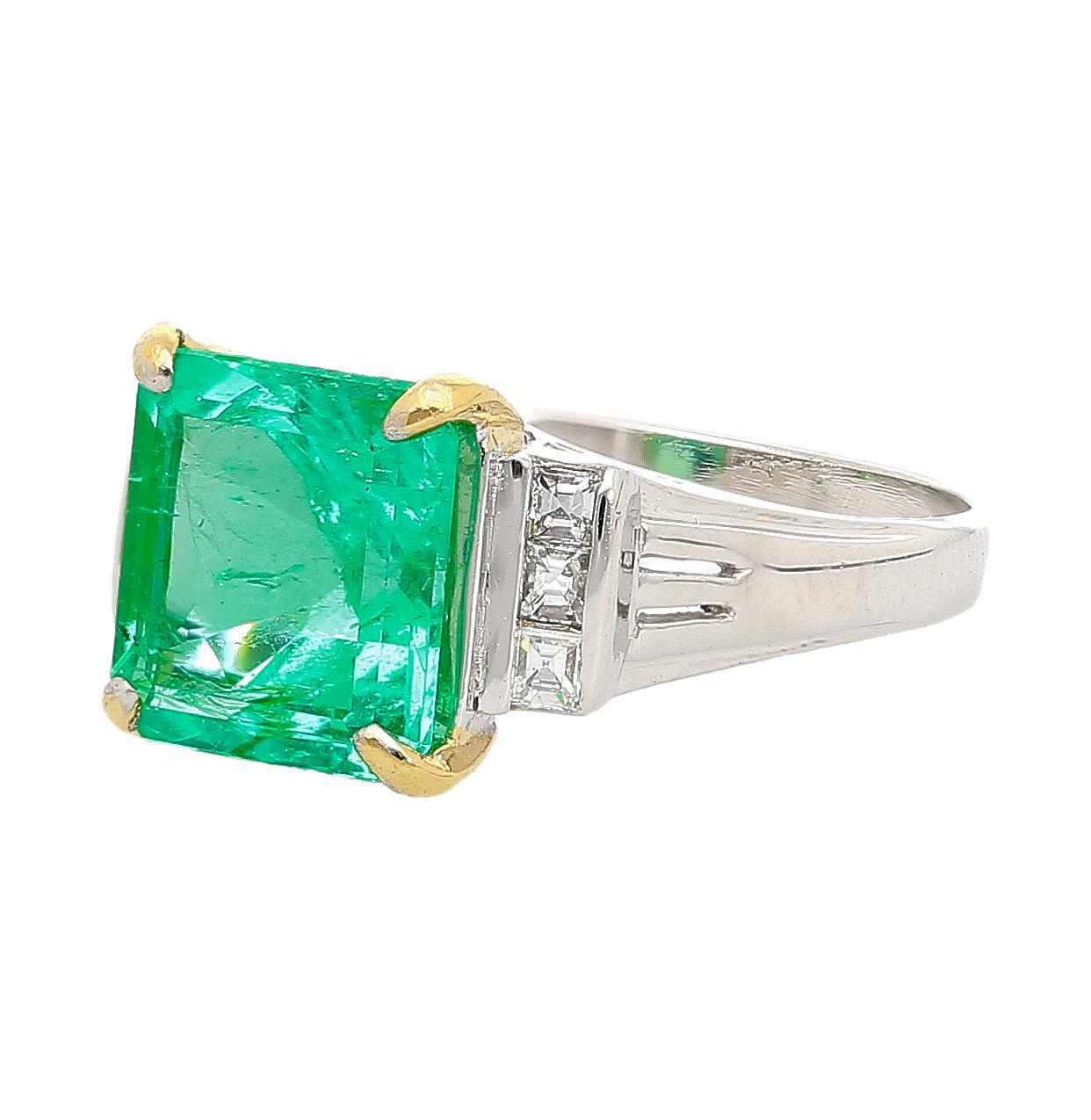 This vintage platinum ring features a GIA Certified Colombian 2.91 carat Colombian emerald with a square emerald cut, accented by 0.18 carat of princess cut diamonds. The setting mixes crisp platinum with bold yellow gold prongs, offering ideal