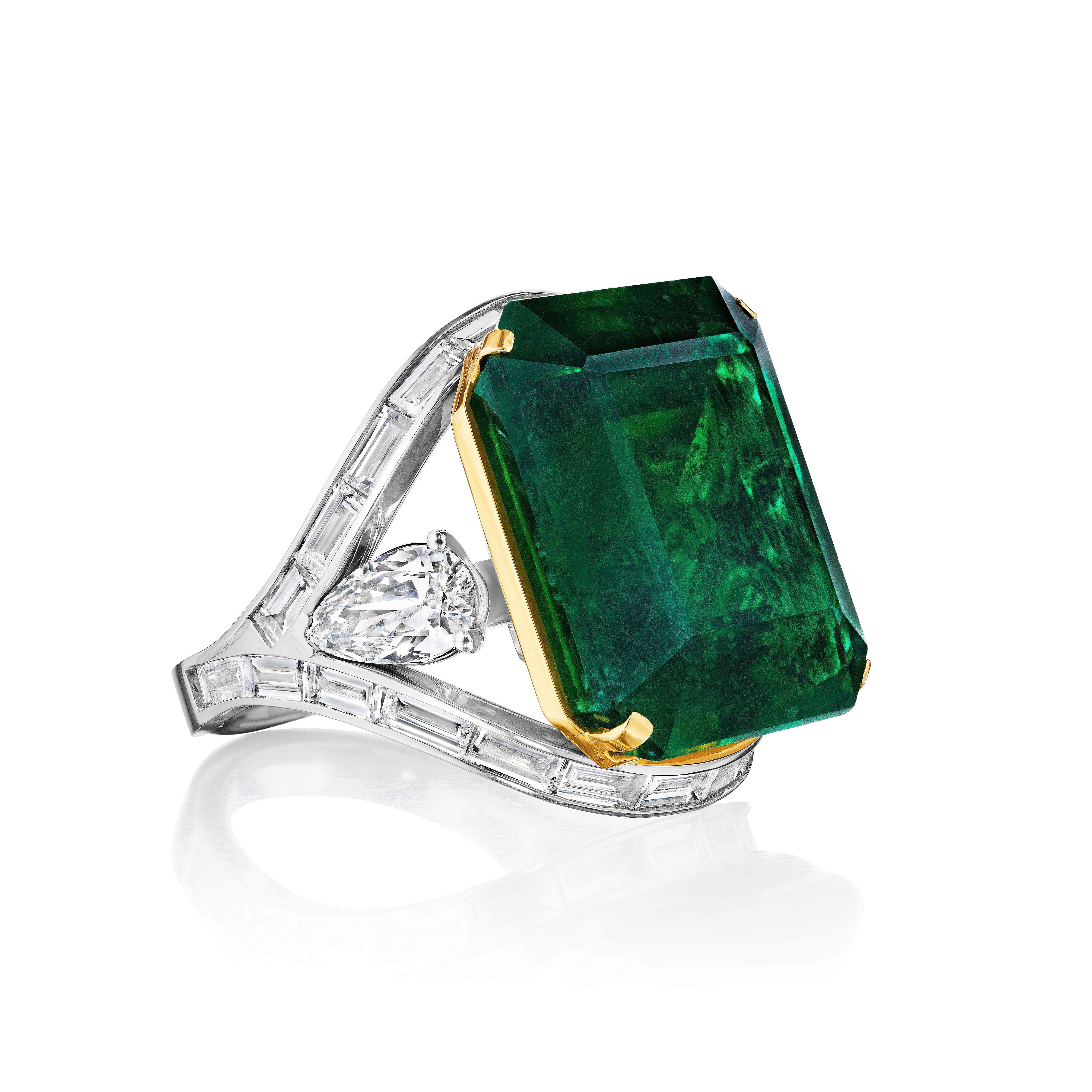 A Fine and unique Statement Emerald and Diamond Ring.

A striking 29.11-carat square-shaped emerald—alone a gem collector’s dream—is set in rich yellow gold and sits atop a beautifully contrasting classically designed platinum baguette-encrusted