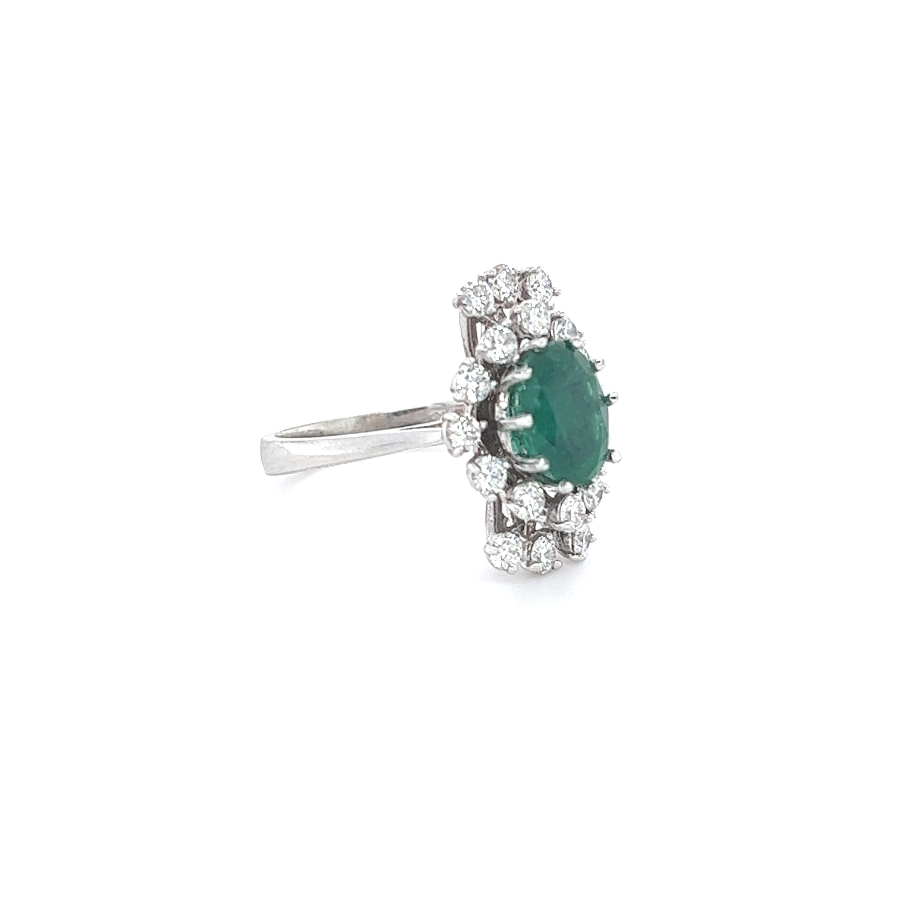 This ring has a 2.01 Carat Oval Cut Emerald and is surrounded by 18 Round Cut Diamonds that weighs 0.91 Carats. (Clarity: SI1, Color: F) The total carat weight of the ring is 2.92 carats. 
The Oval Cut Emerald measures at approximately 9 mm x 7 mm.