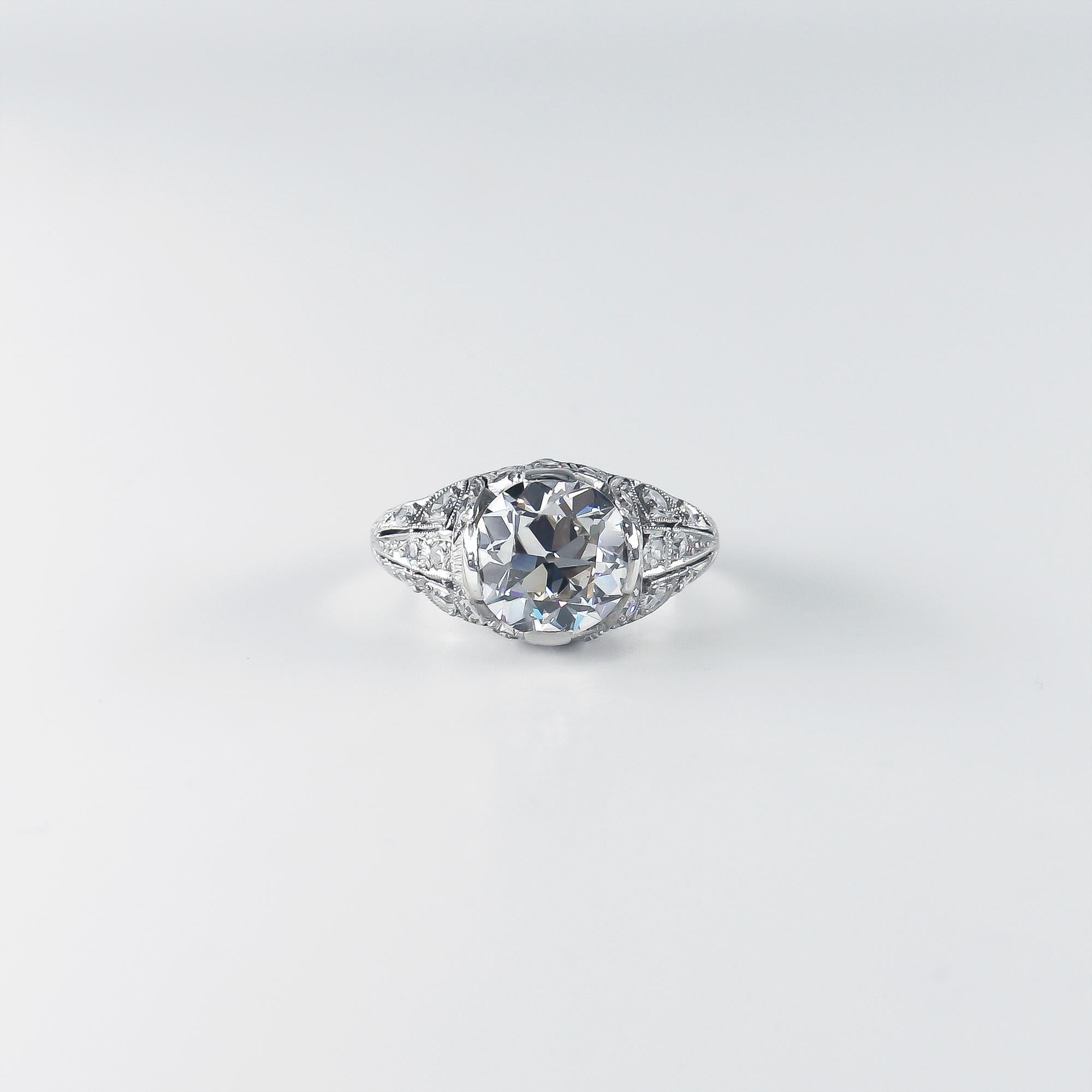 This breathtaking new acquisition by J. Birnbach features a GIA certified 2.93 carat Old European cut diamond of J color and VVS1 clarity as described by GIA grading report #6224242403. Set in a handmade, vintage, platinum ring with assorted
