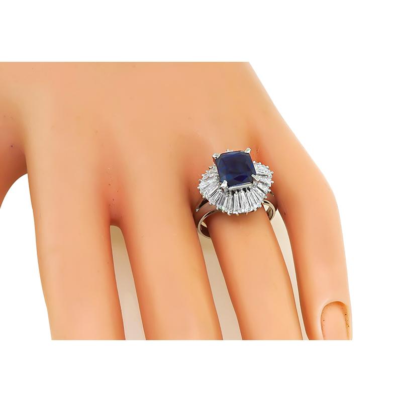 This is an elegant platinum engagement ring. The ring is centered with a lovely GIA certified cushion cut sapphire that weighs 2.97ct. The sapphire is accentuated by sparkling baguette cut diamonds that weigh approximately 2.04ct. The color of these