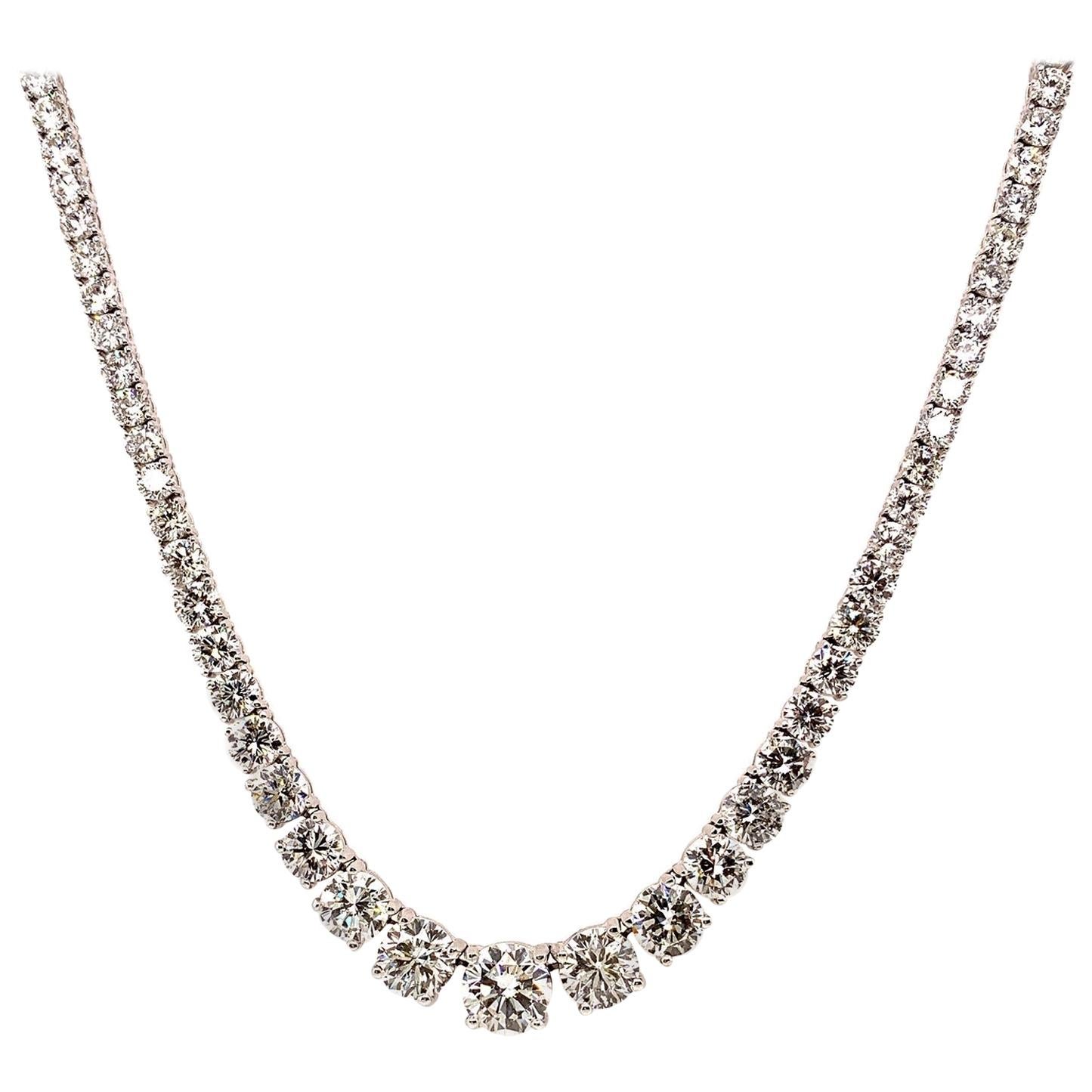 This exquisite riviera necklace in a graduated setting, crafted in handmade 18k gold features perfectly cut ideal round brilliant diamonds. Center stone is a 2 carat stunner which graduates down to 
1 1/2 Carat stones on either side followed by