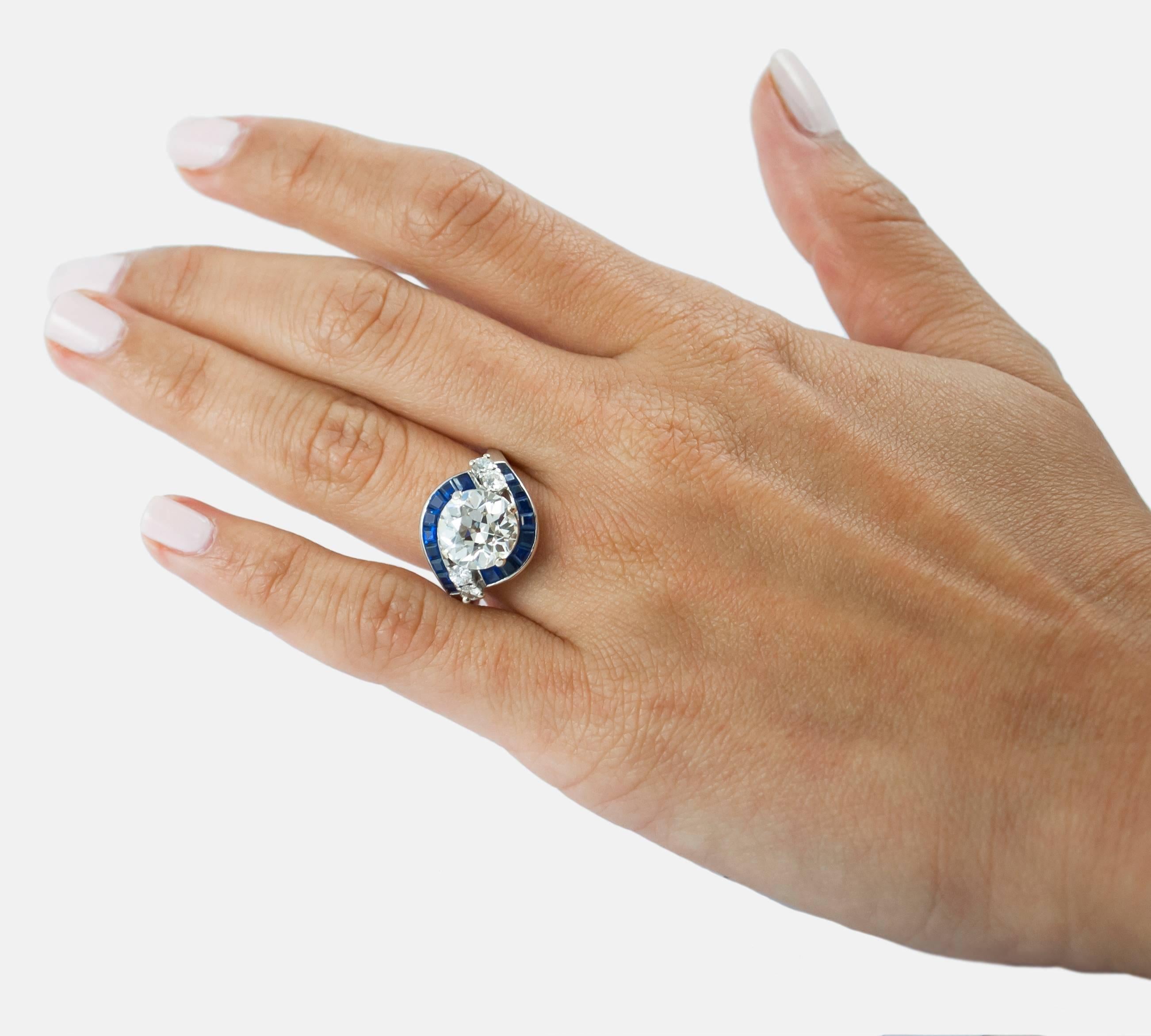 From deep in the vaults comes this 2.99ct Old European Cut diamond ring with sapphires surrounding the center stone. Truly pristine and one of a kind, this ring will be the envy of all your friends. 

This ring comes with a GIA cert stating the