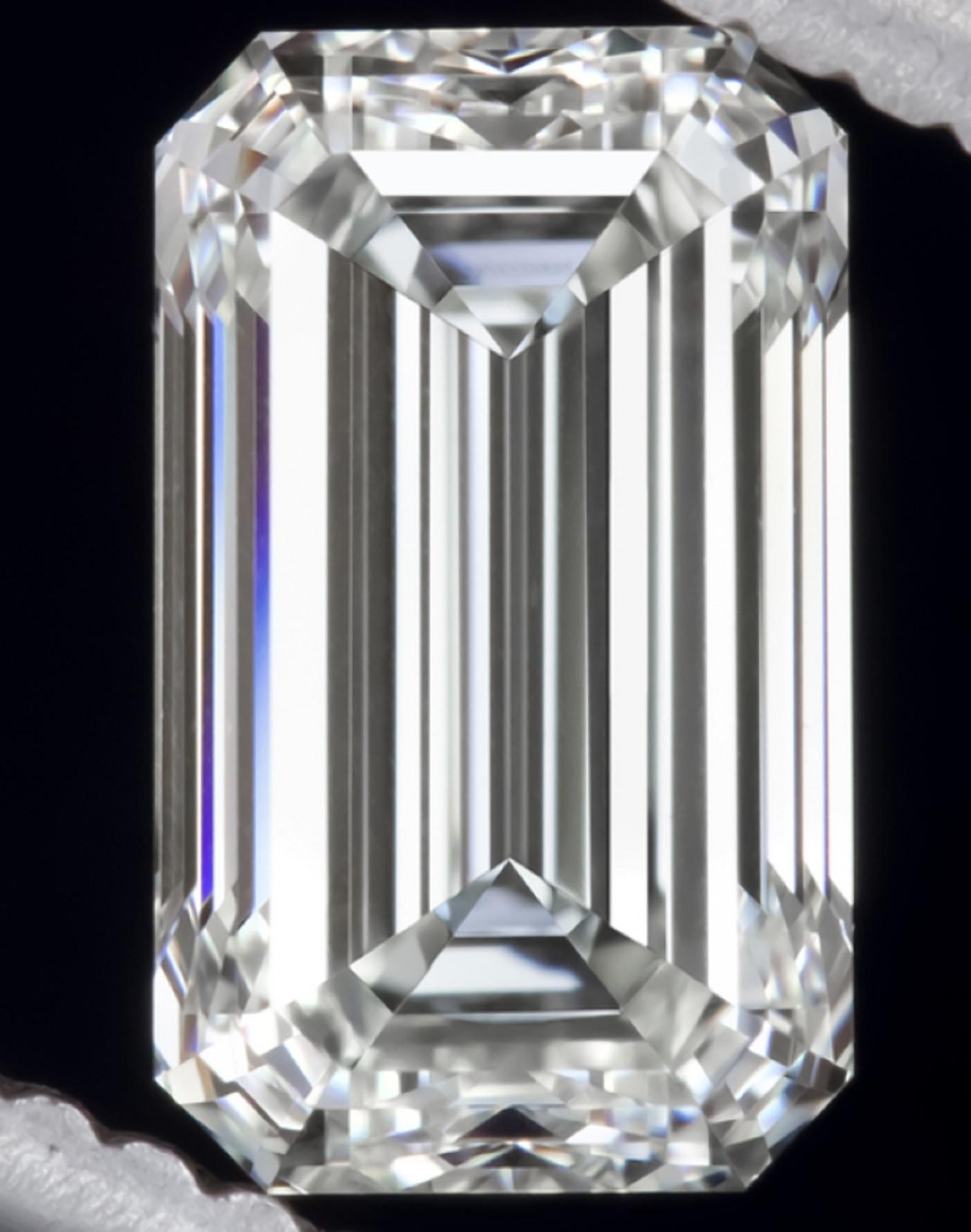This lovely and rare ring centers on a 2.53 carat emerald-cut diamond with vs1  clarity. This stone is flanked by two emerald cut diamonds.

This diamond also has the perfect proportions the ideal emerald cut diamond should have.

Nowdays Emerald
