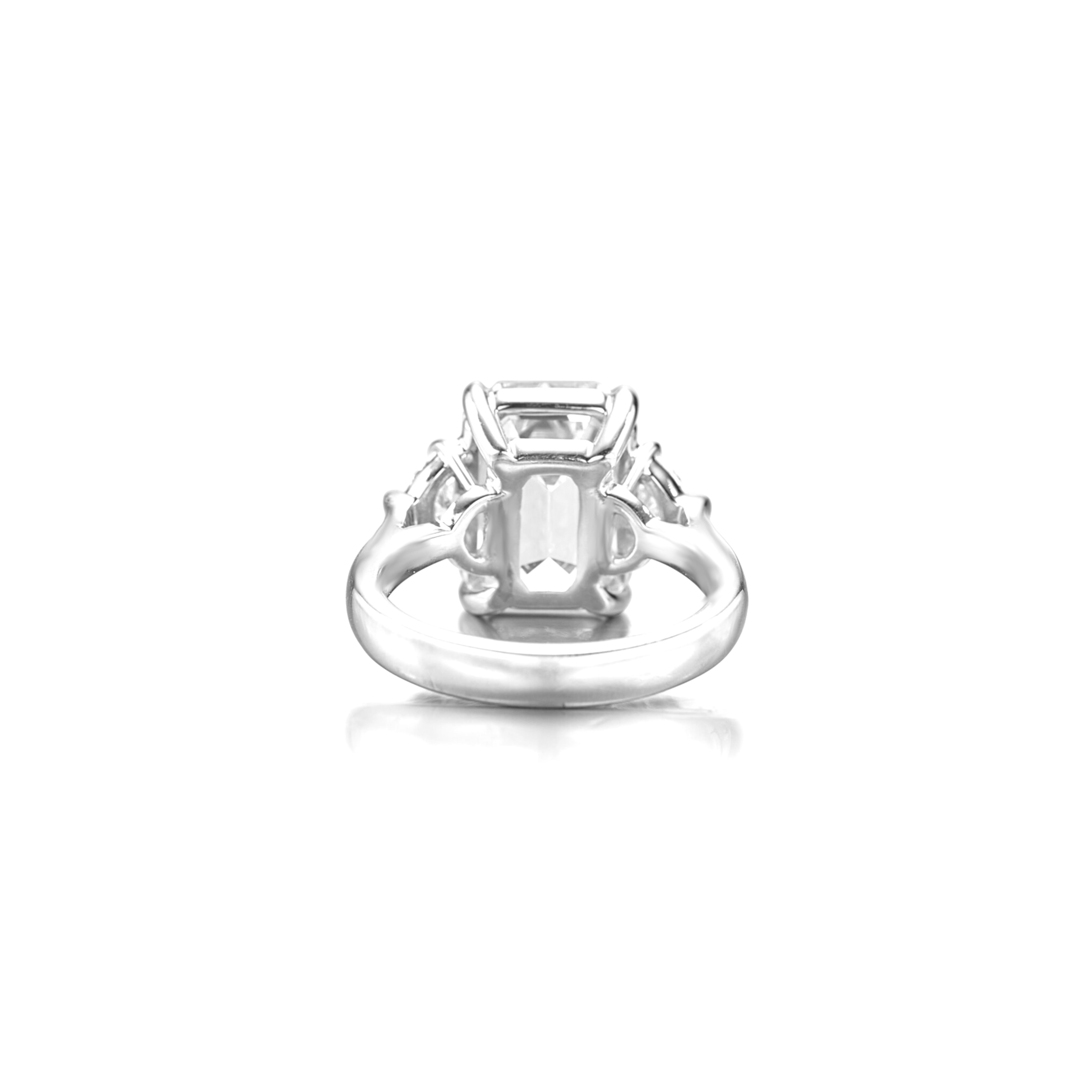 This elegant engagement ring features a GIA certified 3 carat emerald cut diamond set in platinum, showcasing a timeless and architectural silhouette. The center stone is beautifully framed by two pear cut diamonds, adding a graceful contrast that