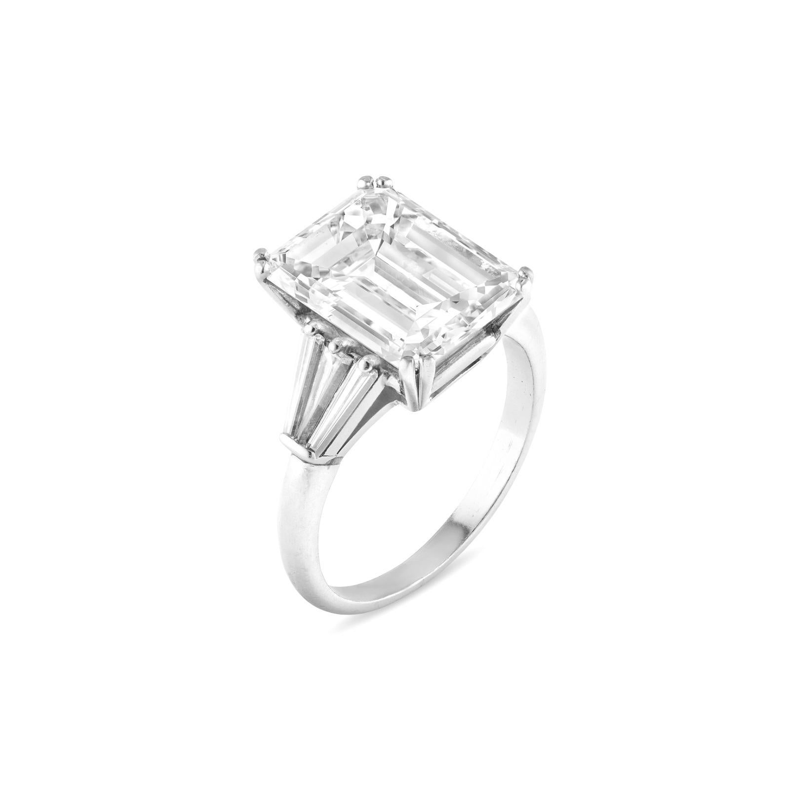 An exquisite engagement ring featuring a total diamond weight of 3 carats. 

 The centerpiece is a gorgeous natural emerald cut diamond that weighs 3 ct, graded as f in color and vvs1 in clarity.

