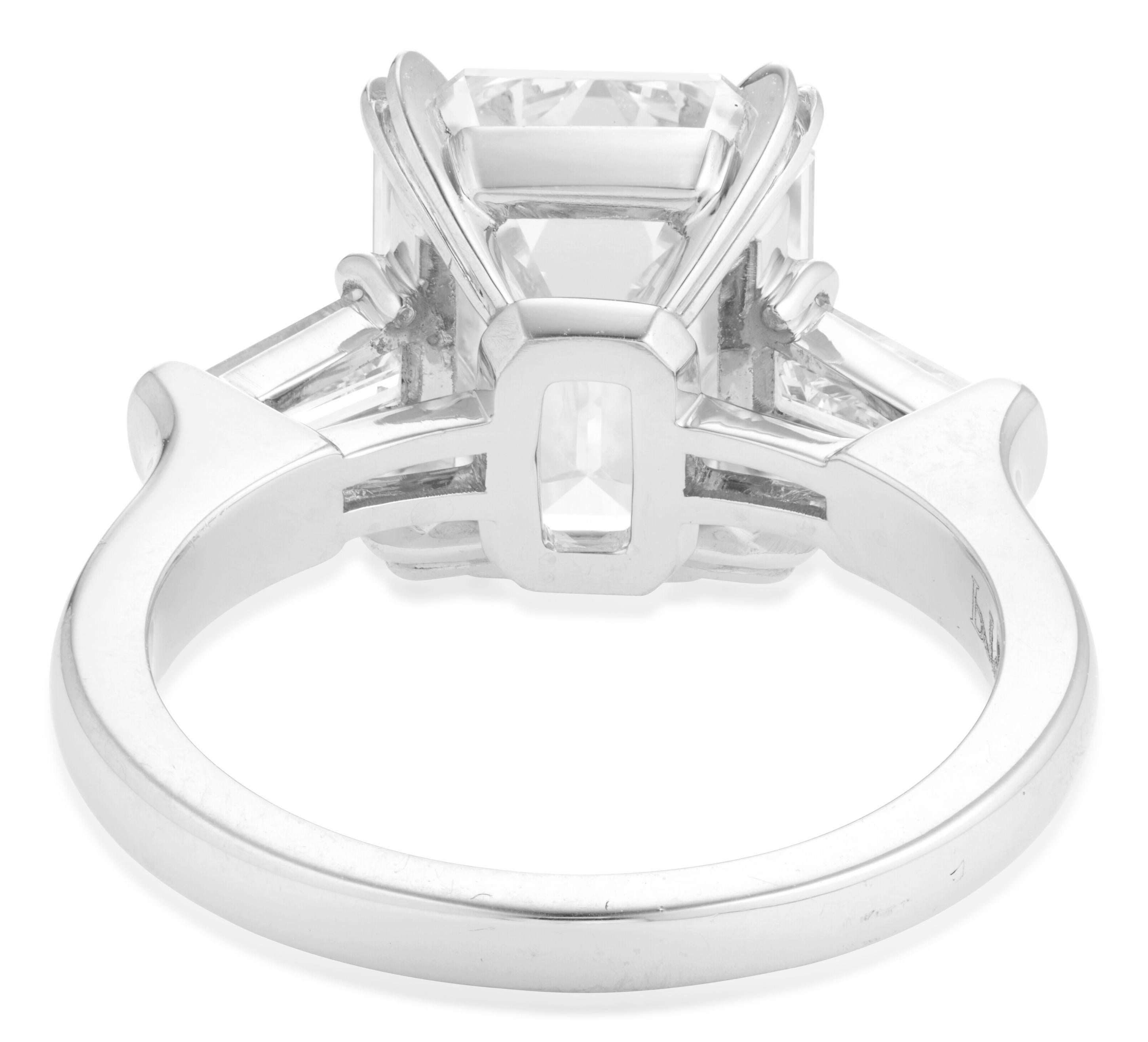 This elegant ring features a 3 carat emerald cut diamond, GIA certified for it's exceptional quality, set in a timeless 18K White Gold band. 

The central diamond is accented by tapered baguette diamonds, enhancing the sleek and refined design. With
