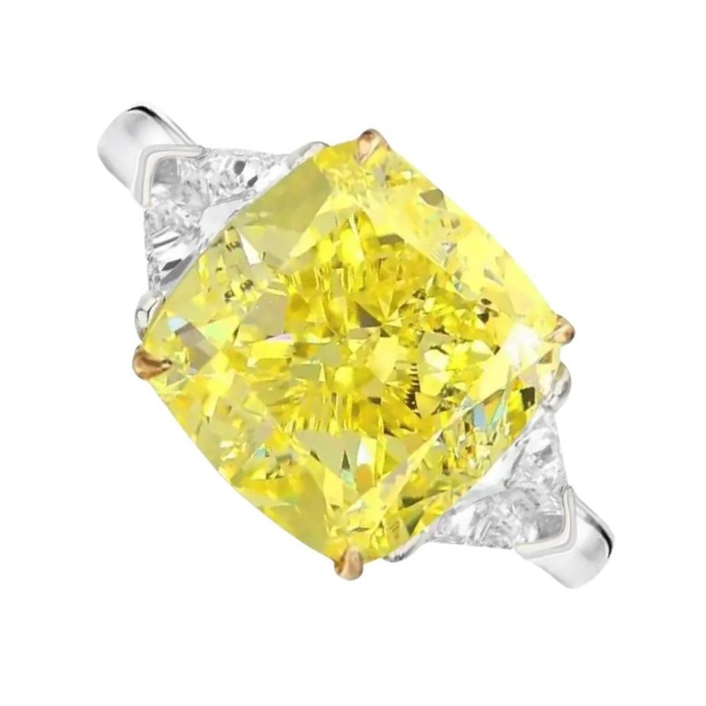 Amazing natural GIA certified fancy yellow cushion cut diamond ring with two side trapezoid natural diamonds at each side mounted in 18 carats yellow gold 

The main stone sparkle is strong yellow. The stone has a tremendous color for an Intense