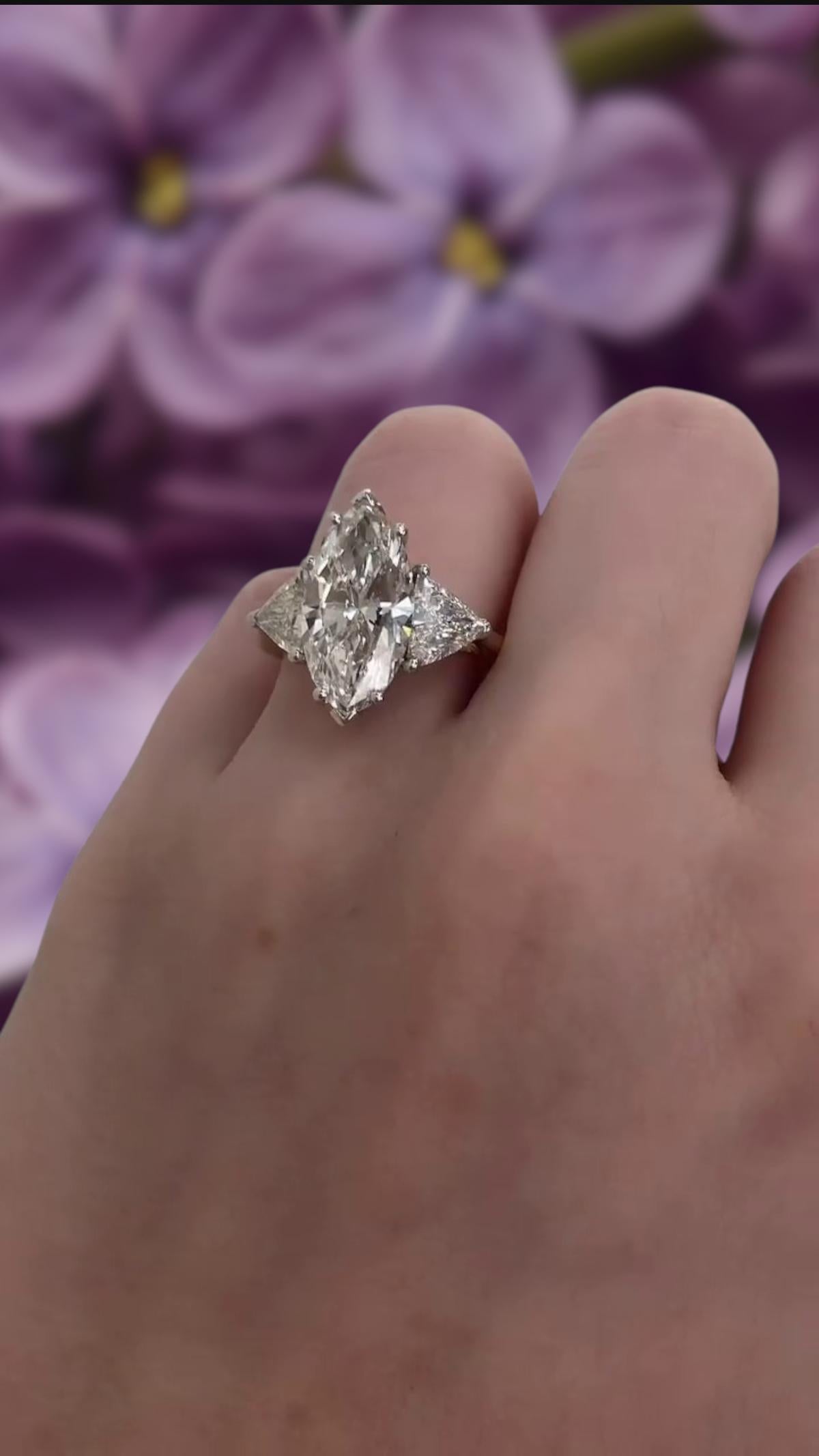 This extraordinary engagement ring features a rare and exceptional 3.02-carat marquise-cut diamond, GIA certified for its outstanding quality. The elongated shape of the center stone enhances its brilliance while creating an elegant and