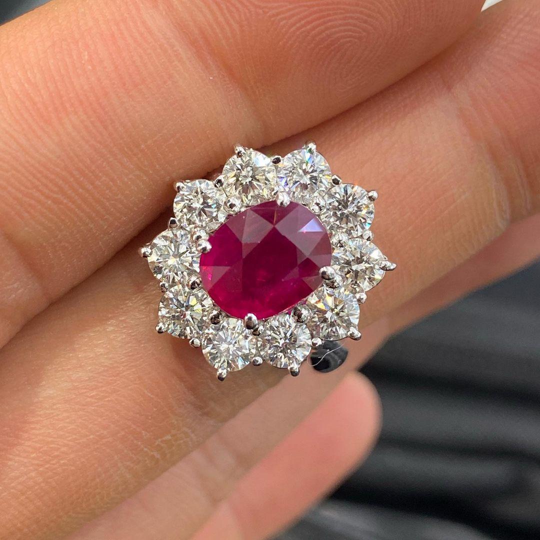 This spectacular oval ruby engagement ring features a magnificent, 2 carat pure red ruby. This world class gem is a beautifully symmetrical oval with ideal color and exceptional brilliance and life. 

It is accompanied by Gemological Institute of