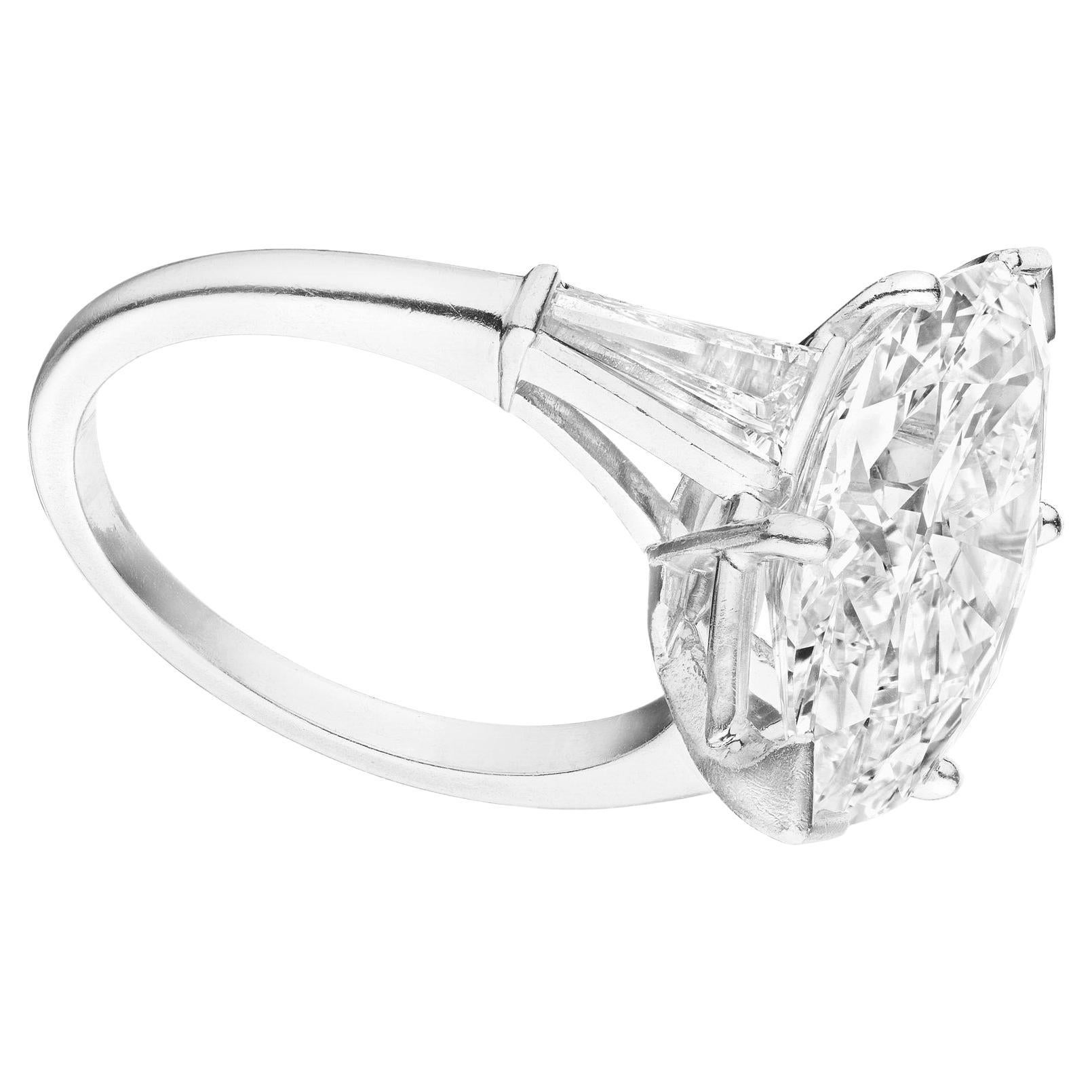 This breathtaking engagement ring features a 3.02 carat marquise cut diamond, certified by GIA for it's exceptional quality. The platinum setting provides a timeless and elegant foundation for the design. Tapered baguette side stones enhance the