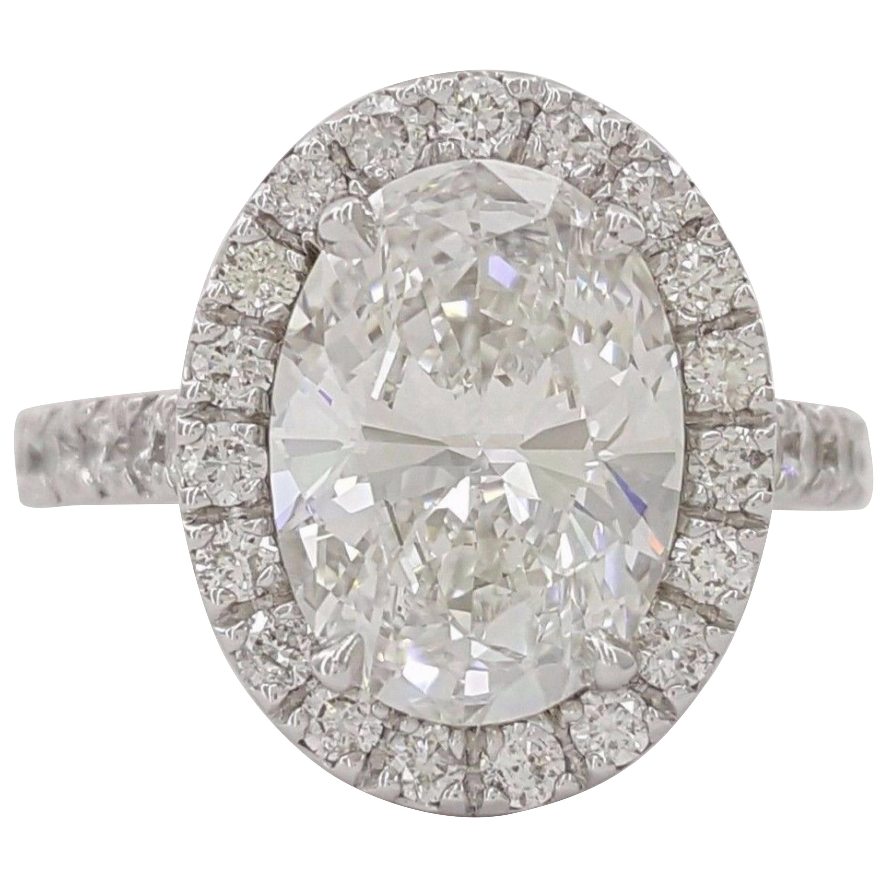 This GIA certified oval cut diamond showcases an exceptional E color grade, offering a beautifully crisp and bright appearance with remarkable brilliance. The diamond’s 3.01 carat weight enhances its presence, making it a striking and elegant