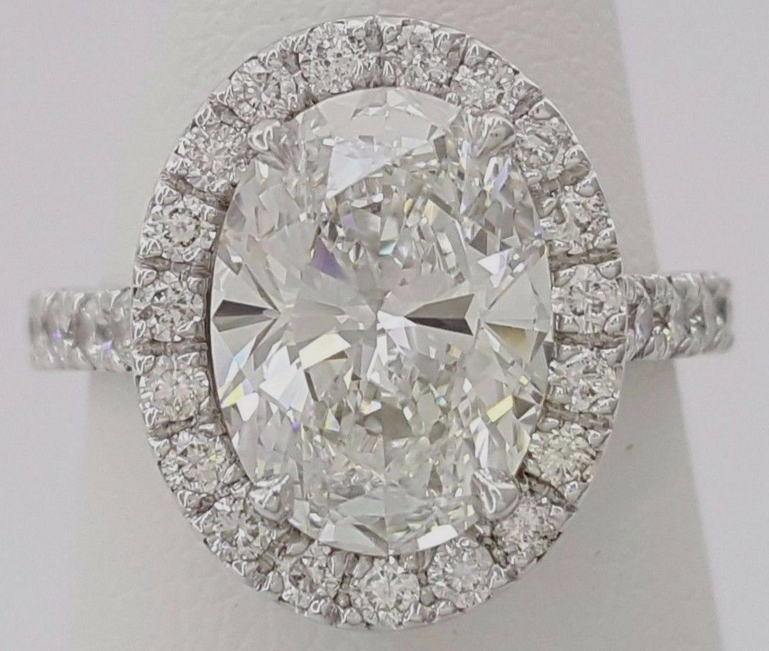 Contemporary GIA Certified 3.01 Carat Oval Cut Diamond Ring with Halo and Pavè in Platinum For Sale