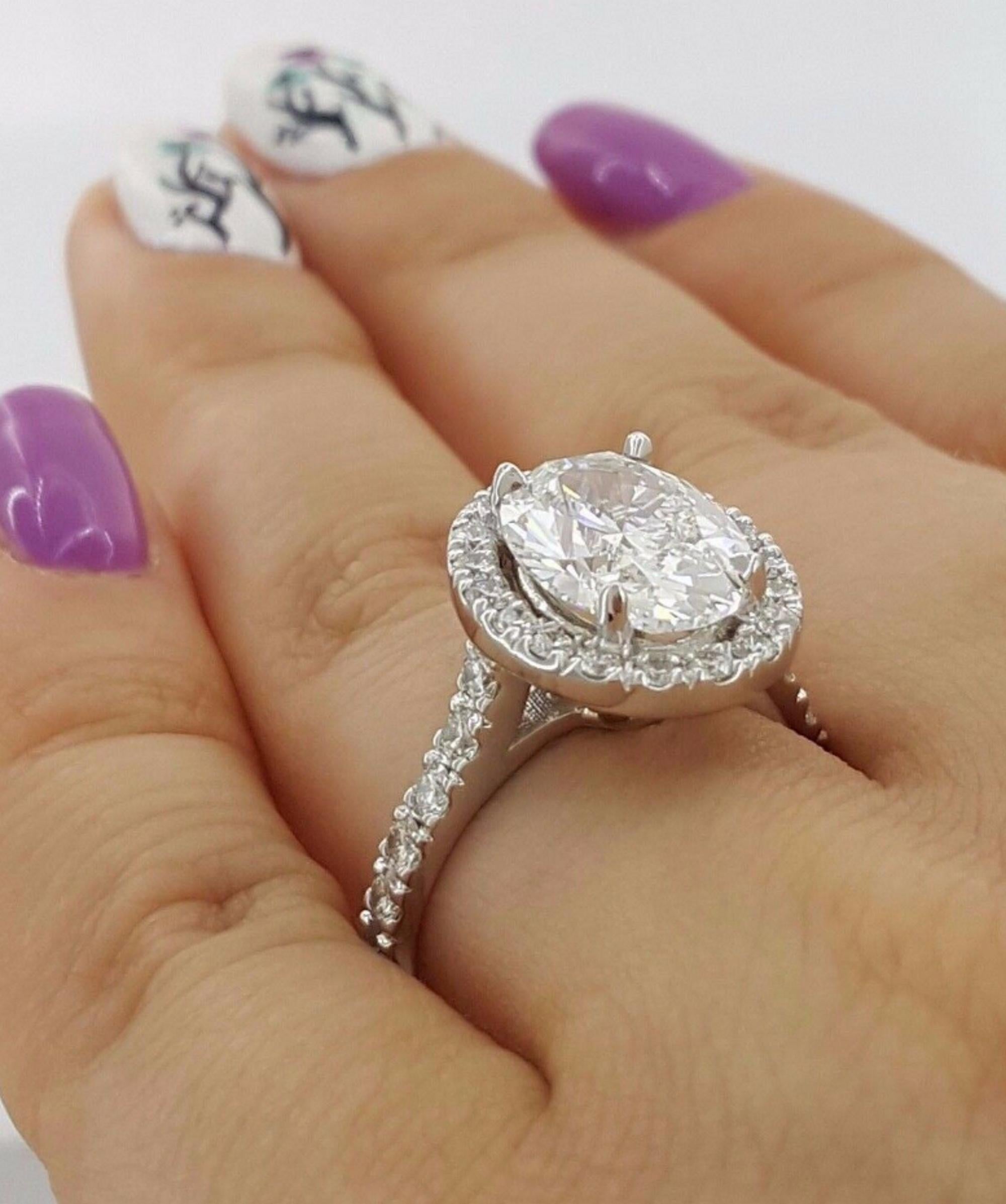 Women's GIA Certified 3.01 Carat Oval Cut Diamond Ring with Halo and Pavè in Platinum For Sale