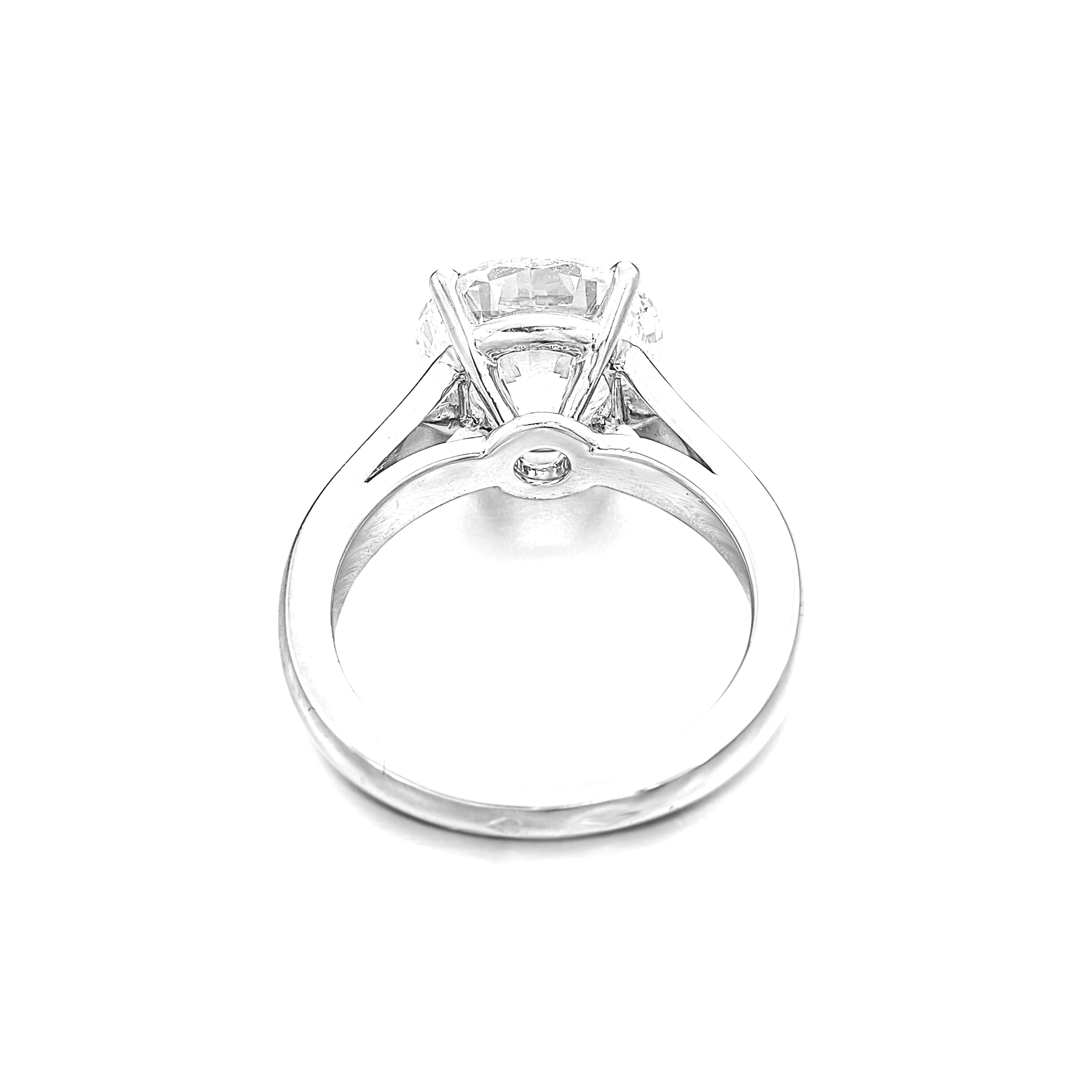 This graceful solitaire engagement ring features a GIA certified 3.01 carat round cut diamond set in refined platinum. 

The stone presents an H color grade, offering a gentle warmth that complements the brilliance of its cut and adds a subtle