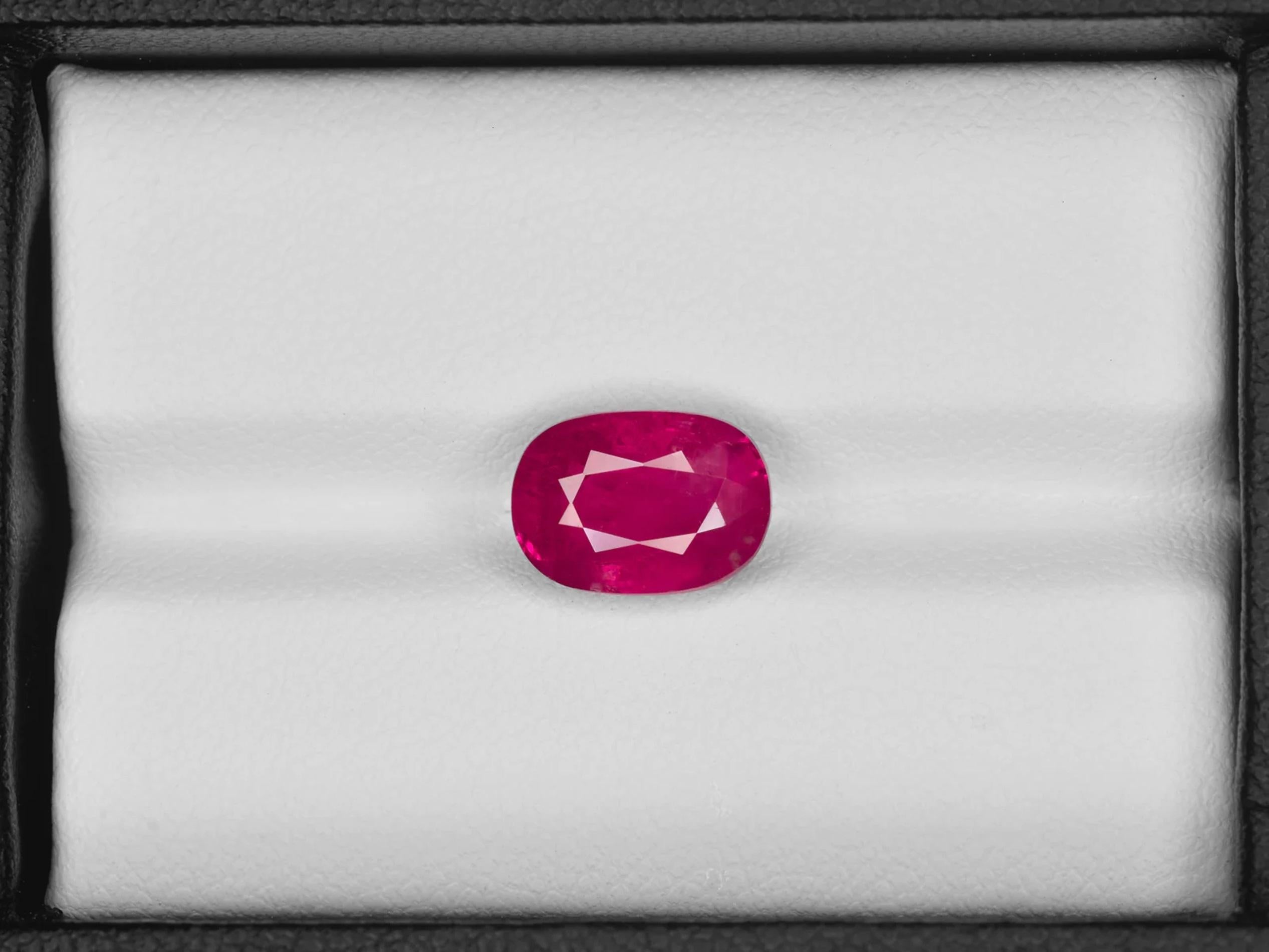 This stunning ring showcases a vibrant 3.02 carat vivid red ruby, certified by the GIA, as its striking centerpiece. The ruby is elegantly set in a combination of platinum and 18K yellow gold, creating a luxurious and timeless appeal. Flanking the