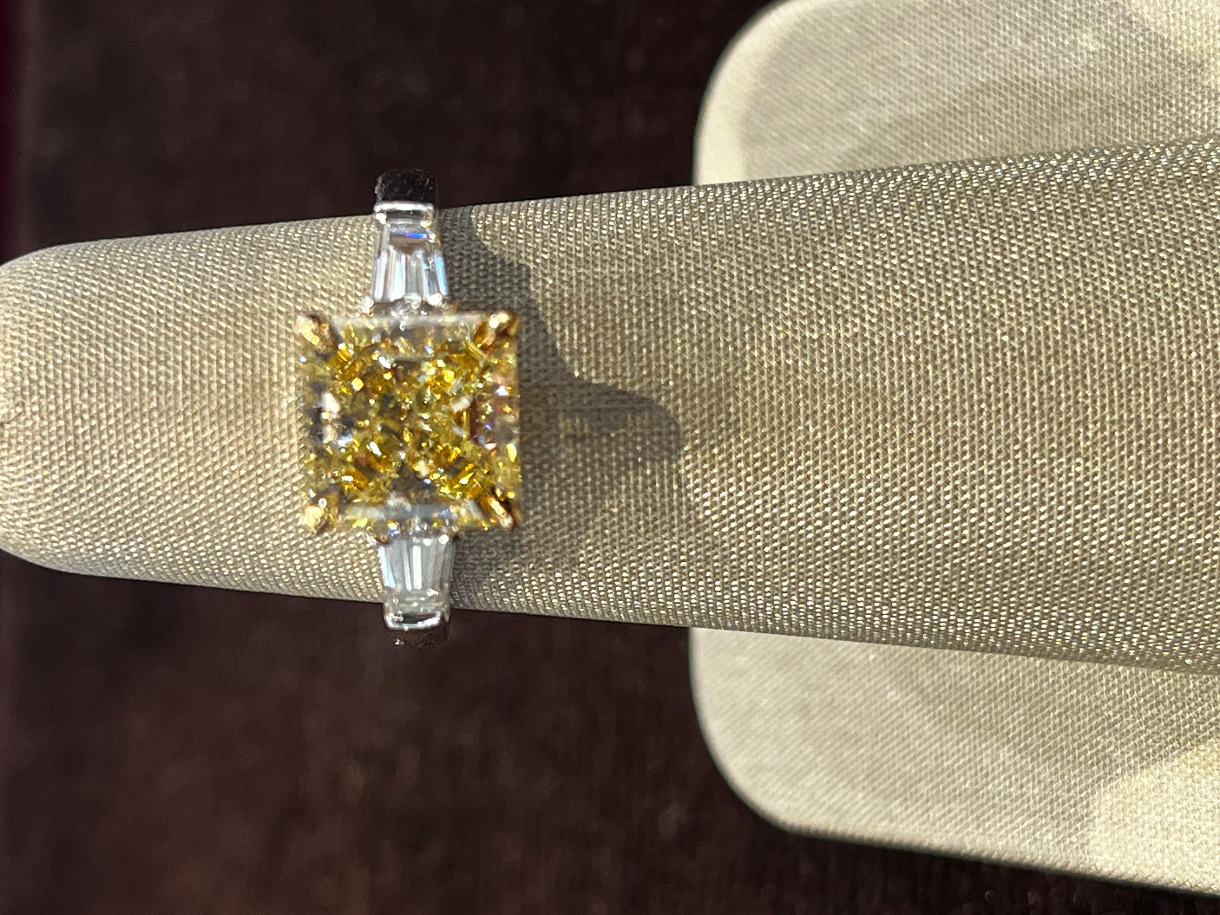 Stone: Diamond

Color: Fancy Light Yellow

Carat Weight: 3.03cts

Clarity: VVS1

Cut: Princess Cut

Metal: Platinum 950 and 18k Yellow Gold

Measurements: 8.08 x 8.01 x 5.27

Side stones: 0.52 total carat weight E color, VS1 clarity