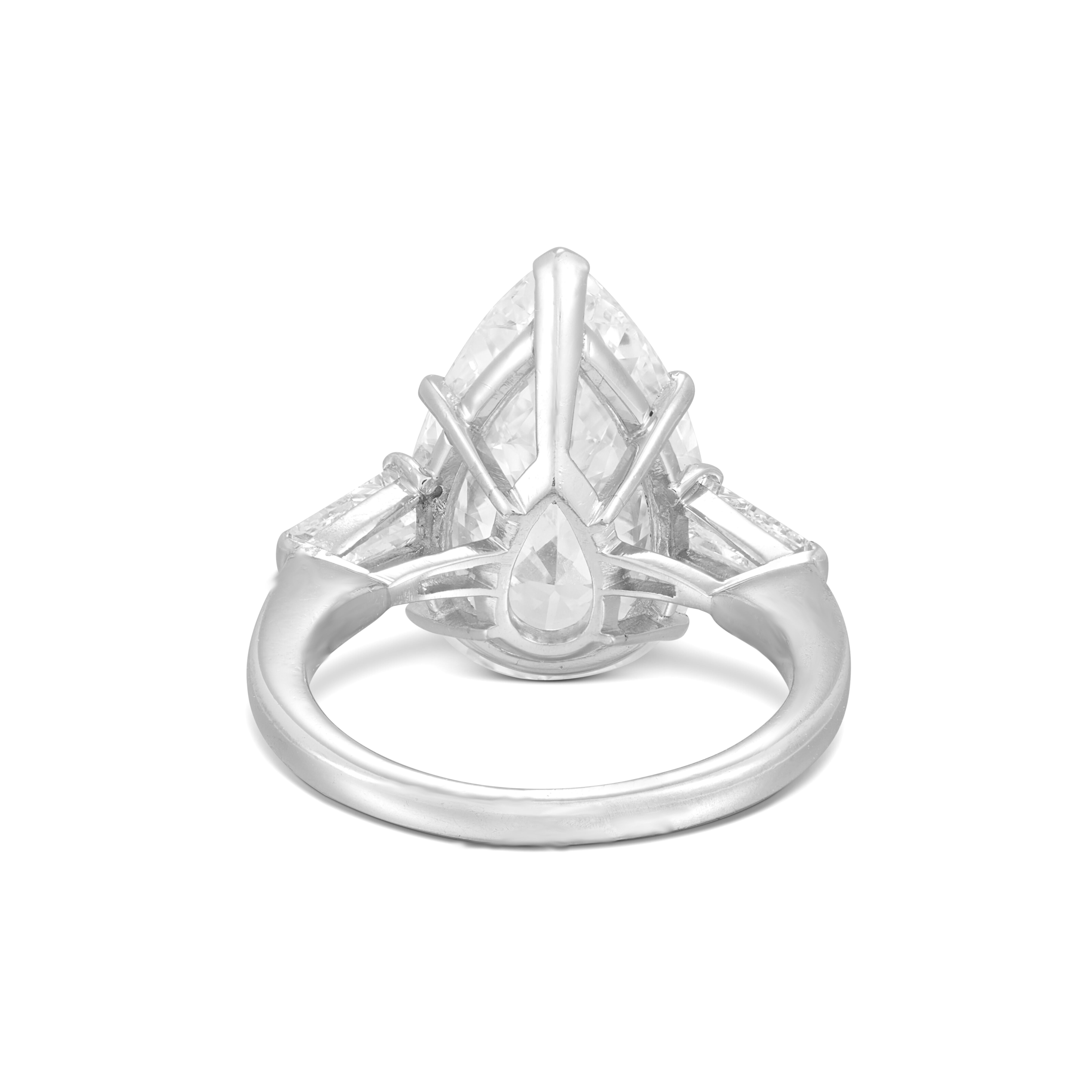 GIA Certified 3 Ct. Pear Cut Diamond Ring, elegantly set in luxurious platinum. This stunning piece features two beautiful tapered baguette diamonds, showcasing g color and VVS clarity, enhancing the ring's brilliance and sophistication. Perfect for