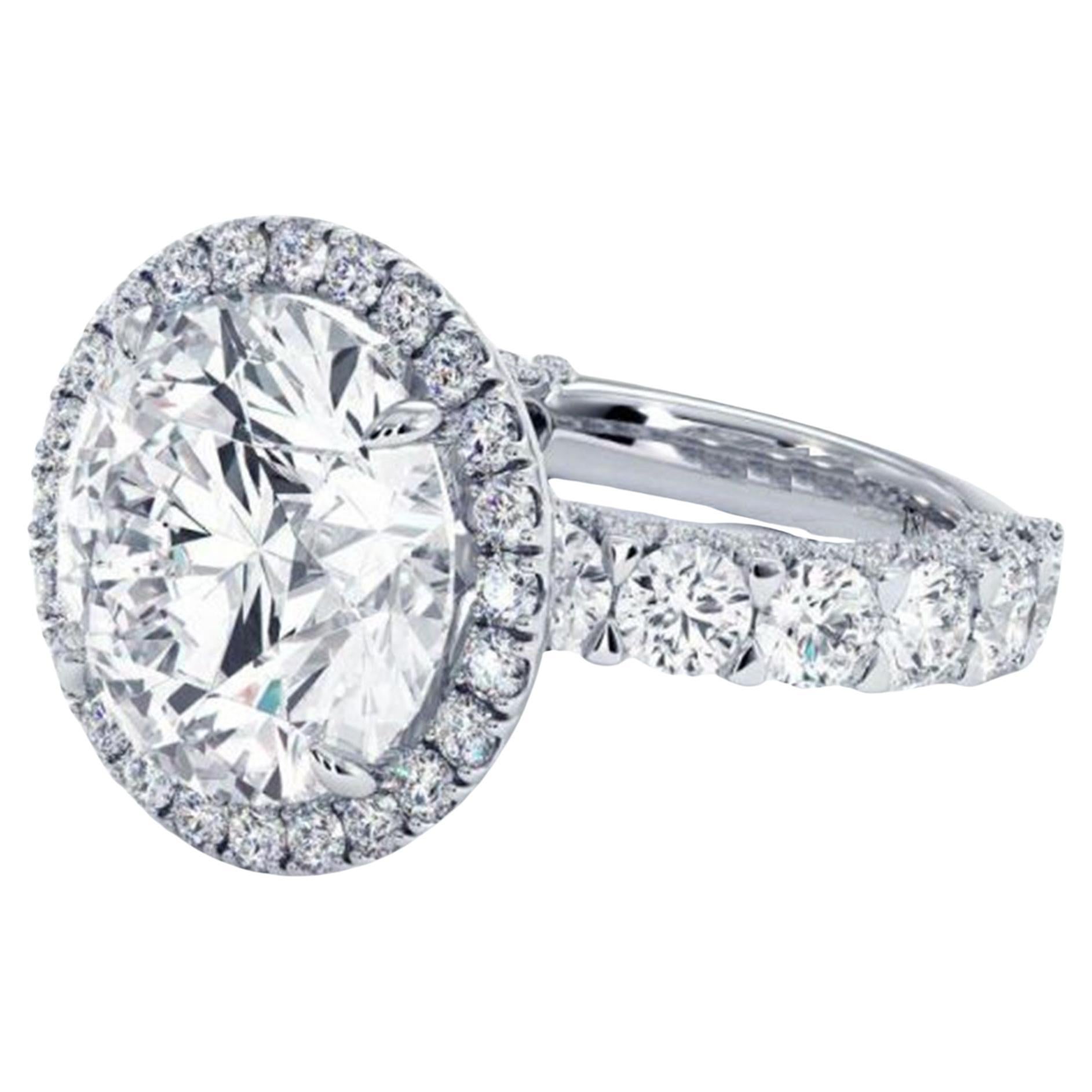 This stunning GIA Certified ring features a 3.51 carat round cut diamond at its center, encircled by a delicate halo of smaller diamonds that amplify its radiant sparkle. 


With a D color grade, the diamond offers the highest level of color purity,